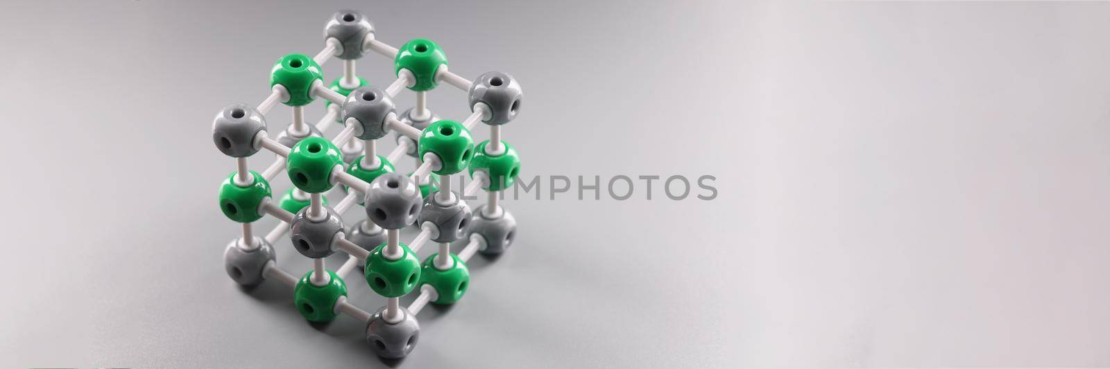 Close-up of molecular dna model structure on grey surface, cells connected to each other. Laboratory, science, chemistry, investigation concept. Copy space