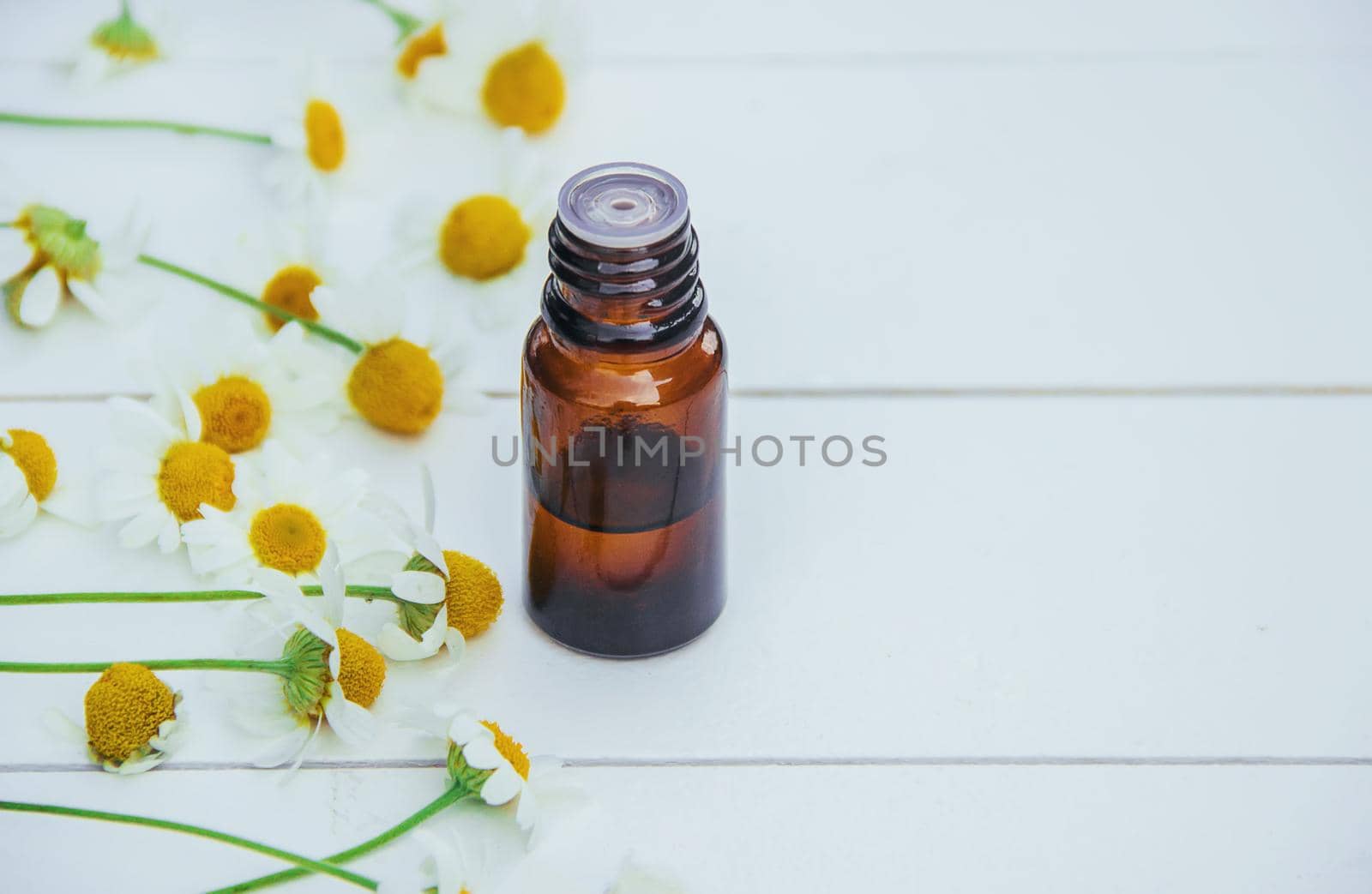 Chamomile extract in a small bottle. Selective focus.