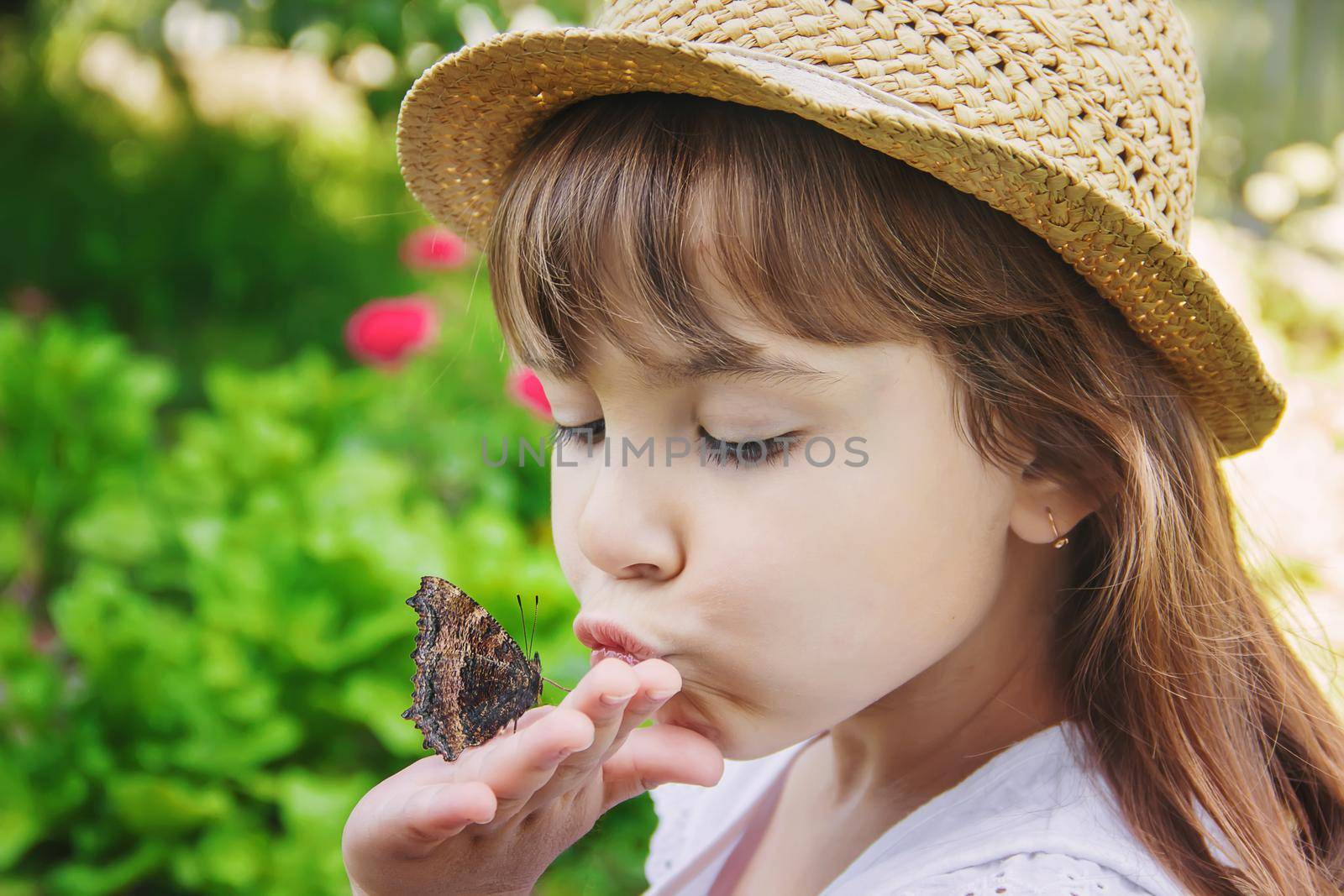 Child with a butterfly. Idea leuconoe. Selective focus.