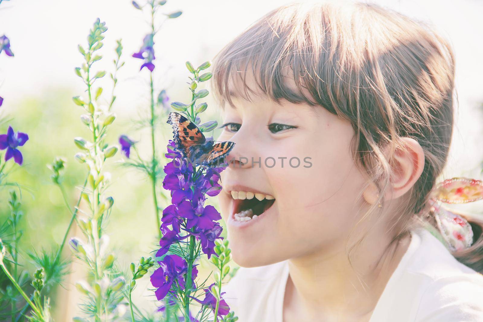 Child with a butterfly. Idea leuconoe. Selective focus.