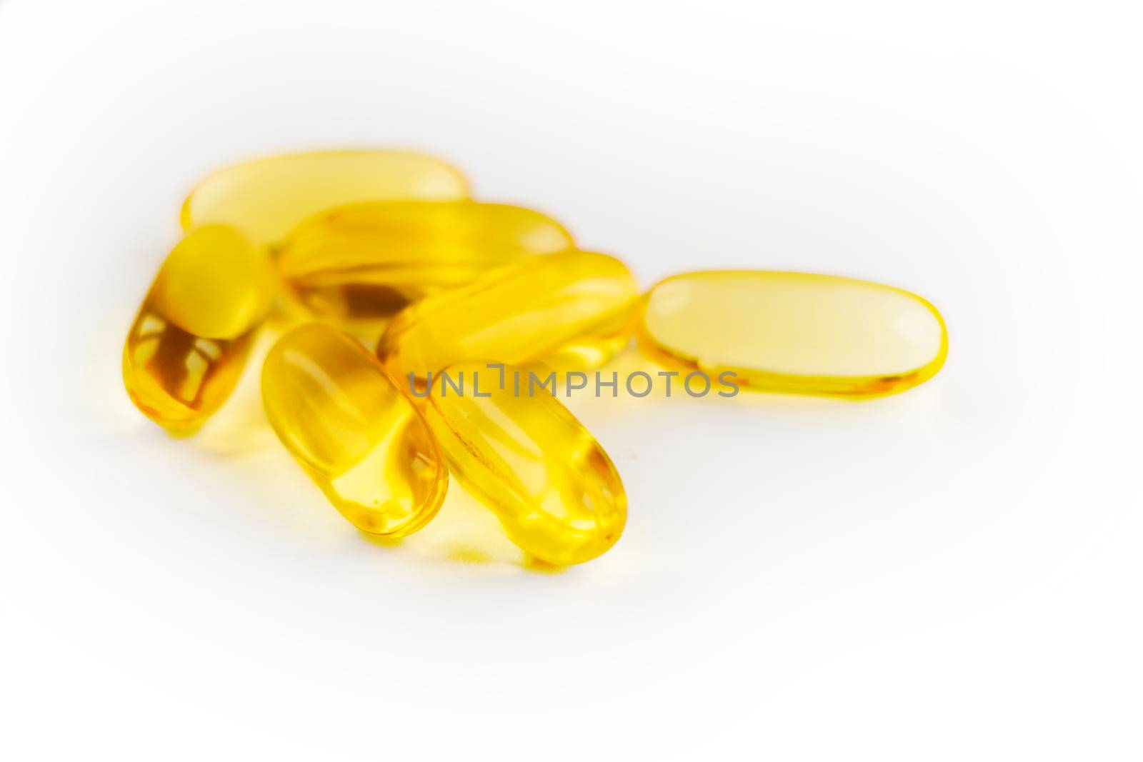 selective focus. Fish oil supplement capsule isolated on white background. Omega 3 capsules, yellow soft gels capsules, Sacha inchi oil, Yellow oil pills. health care concept. High quality photo