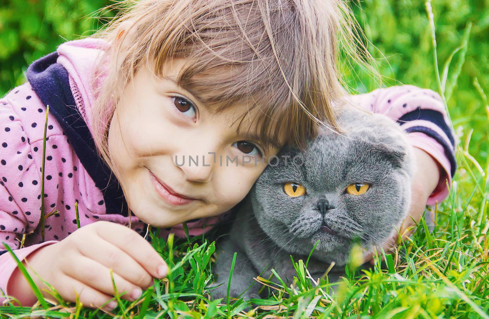 A child and a cat. Selective focus.