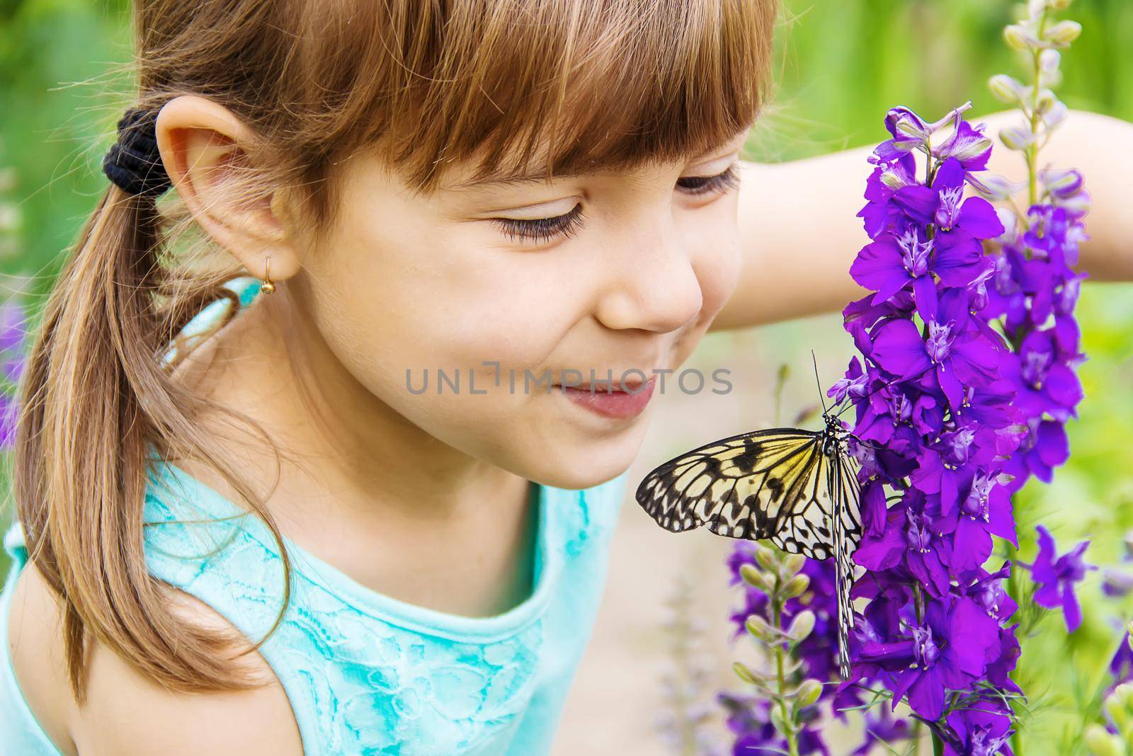 Child with a butterfly. Idea leuconoe. Selective focus.