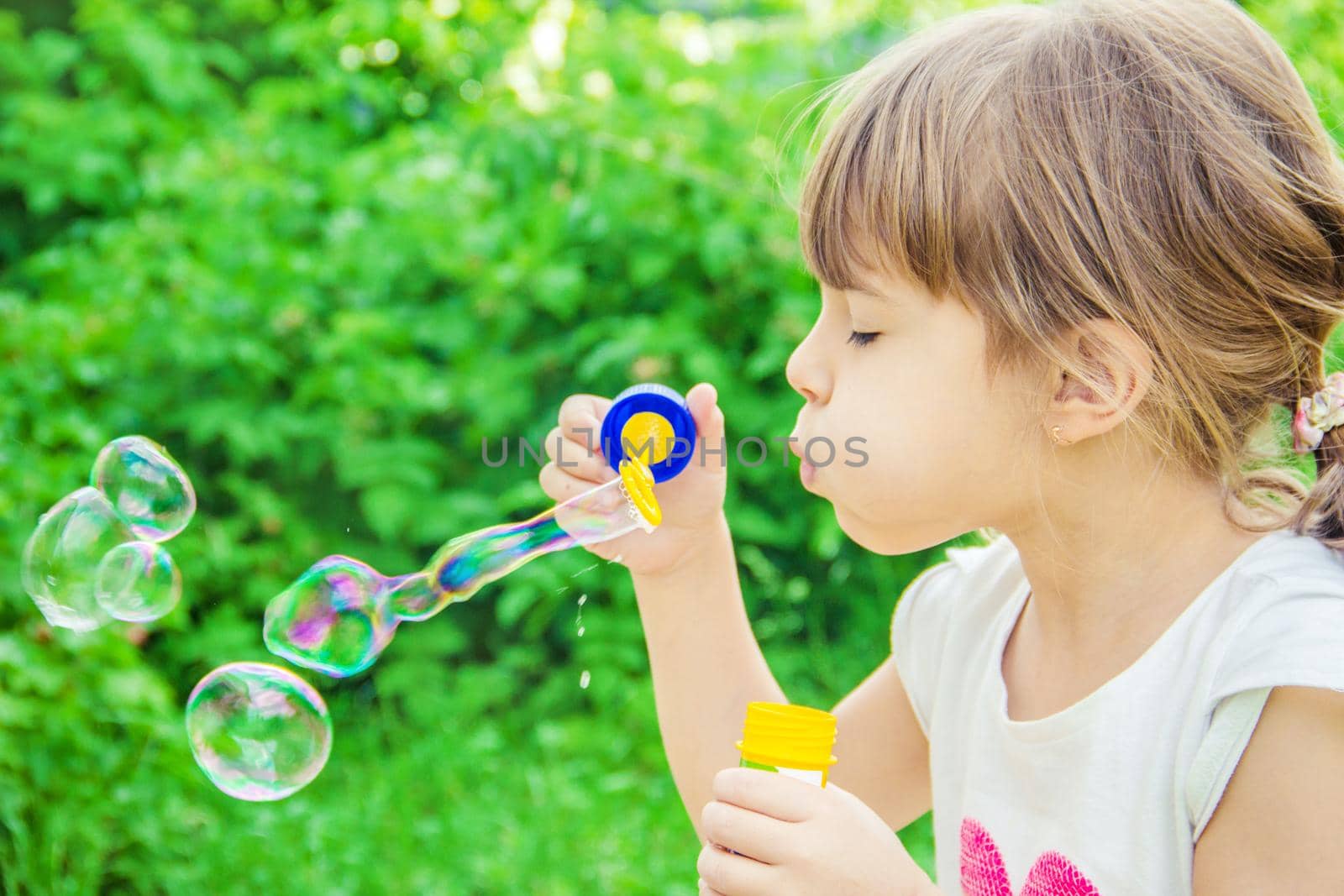 The children are blowing bubbles. Selective focus.