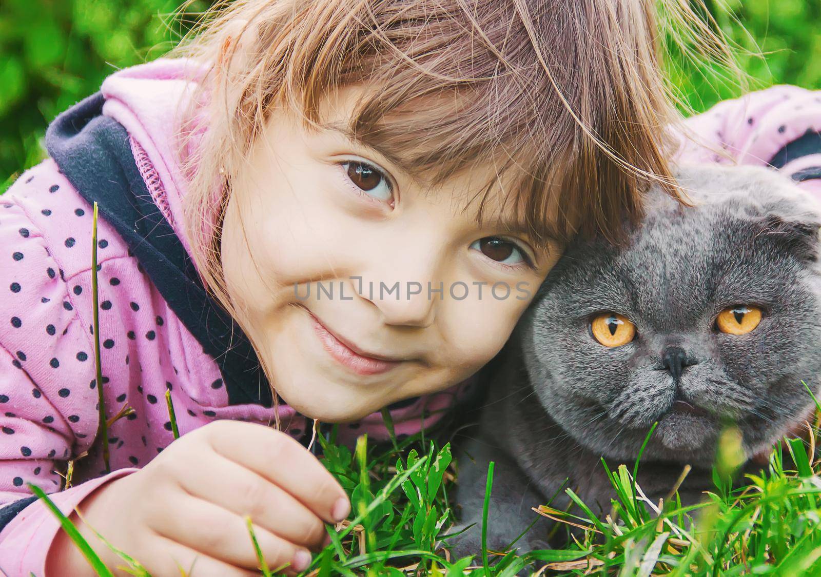 A child and a cat. Selective focus. by yanadjana