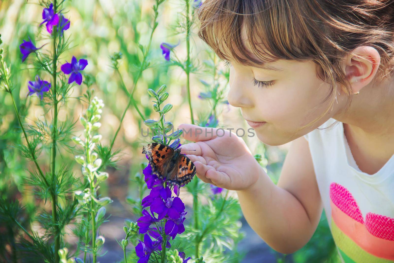 Child with a butterfly. Idea leuconoe. Selective focus.