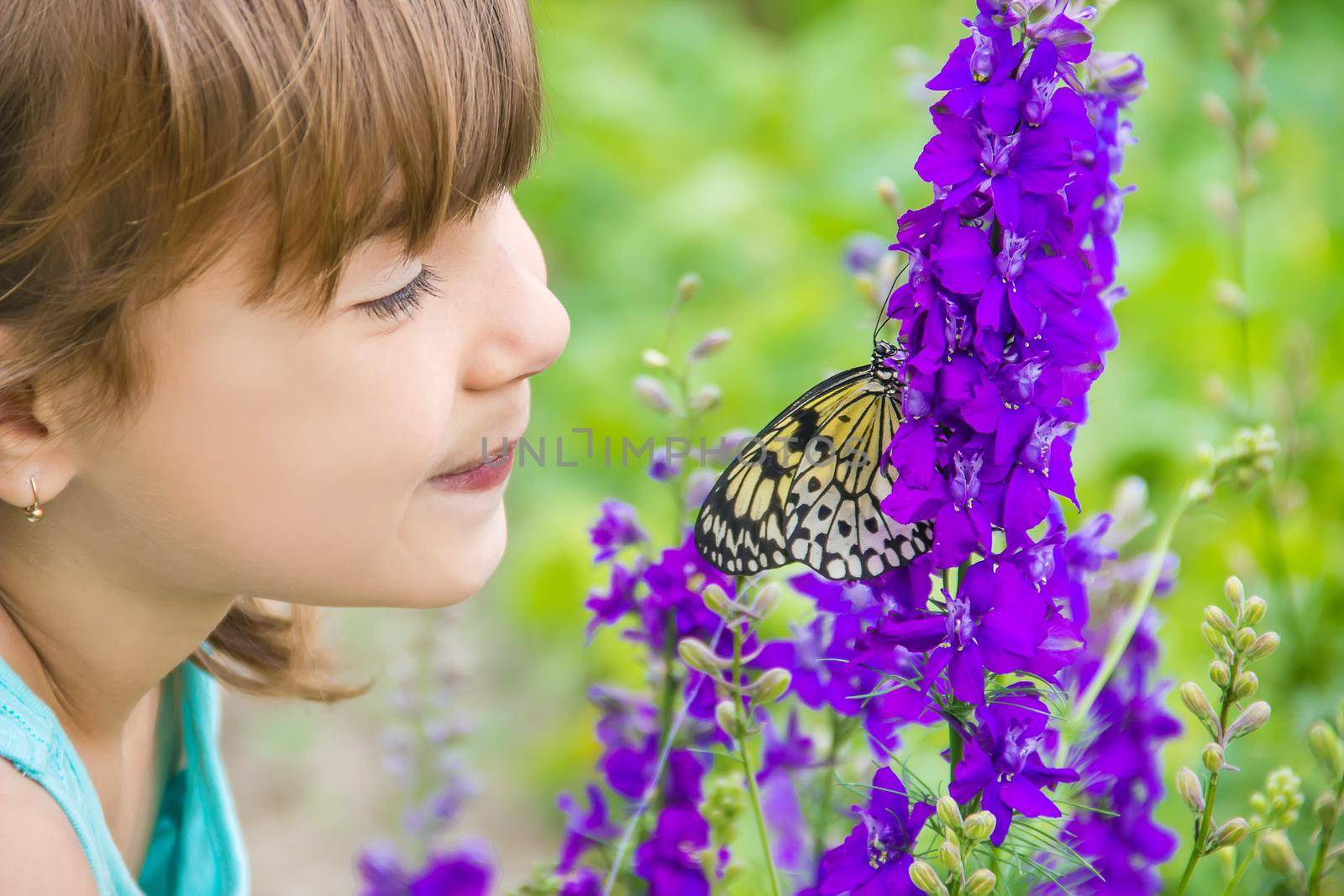 Child with a butterfly. Idea leuconoe. Selective focus.