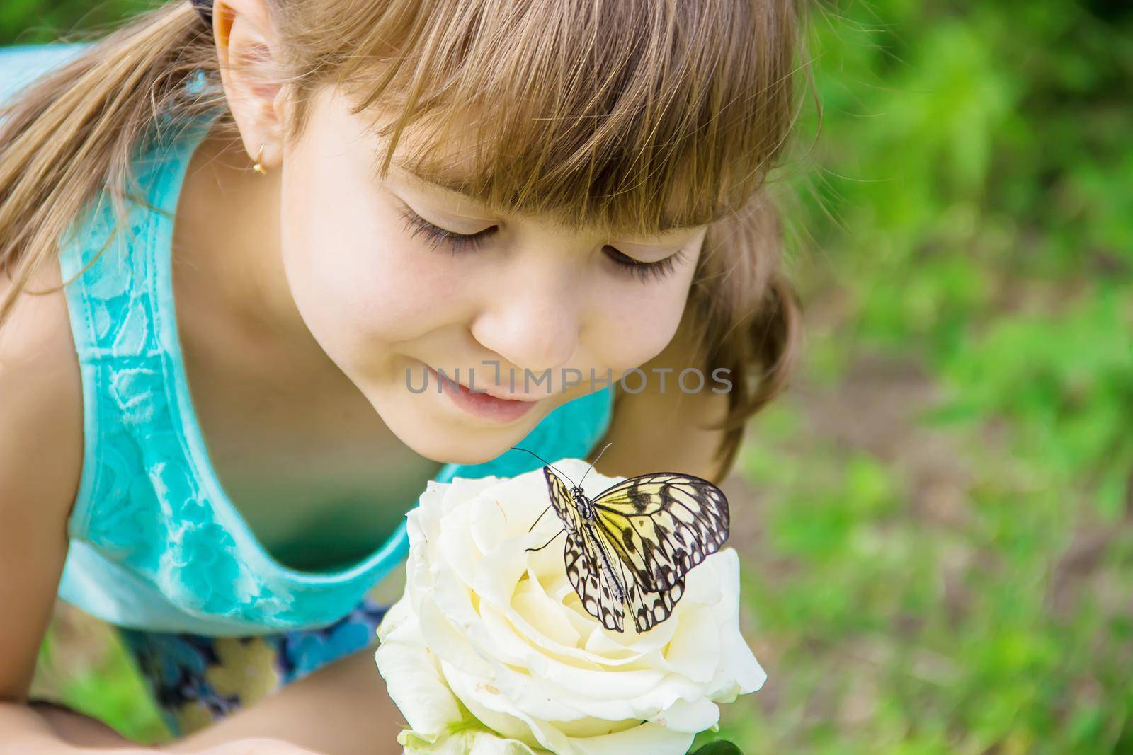 Child with a butterfly. Idea leuconoe. Selective focus.