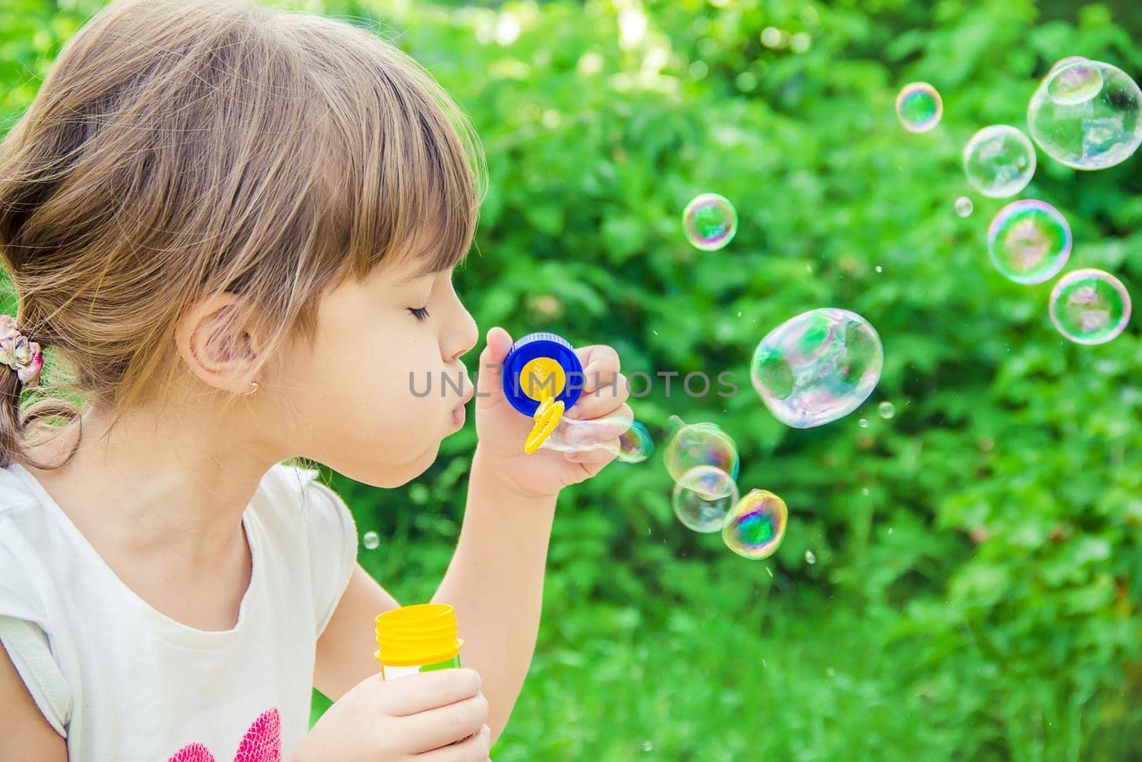 The children are blowing bubbles. Selective focus.