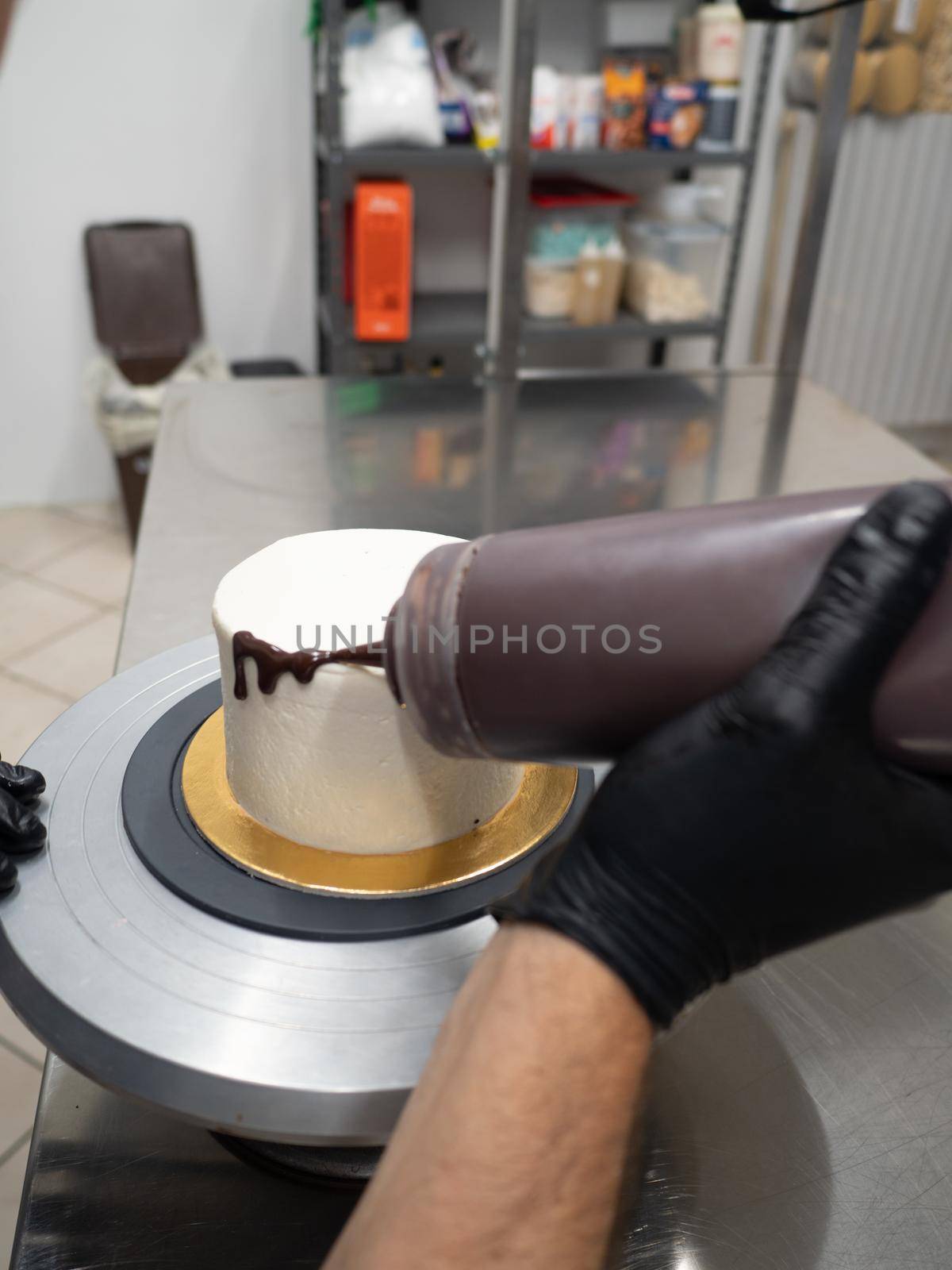 decorating a frosted cake with chocolate and nutella