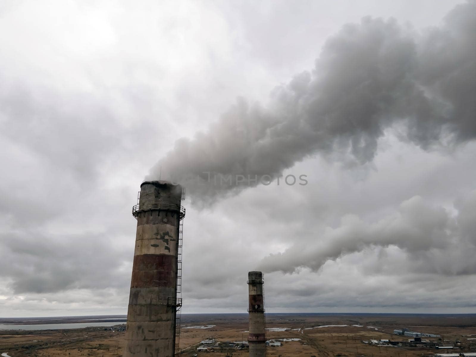 Atmospheric pollution,harmful emissions and global warming,ecological problem.Smoky chimneys of the power plant aerial view.Electric power generation,power plant for burning coal.Thick smoke from fuel