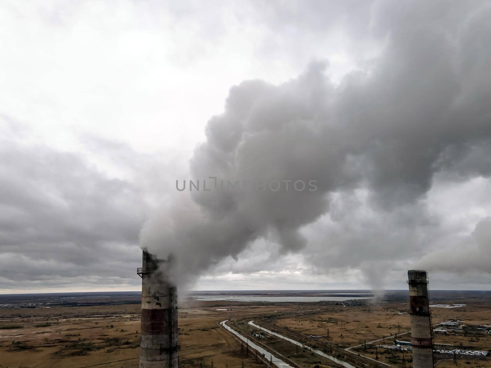 Atmospheric pollution,harmful emissions and global warming,ecological problem.Smoky chimneys of the power plant aerial view.Electric power generation,power plant for burning coal.Thick smoke from fuel by YevgeniySam