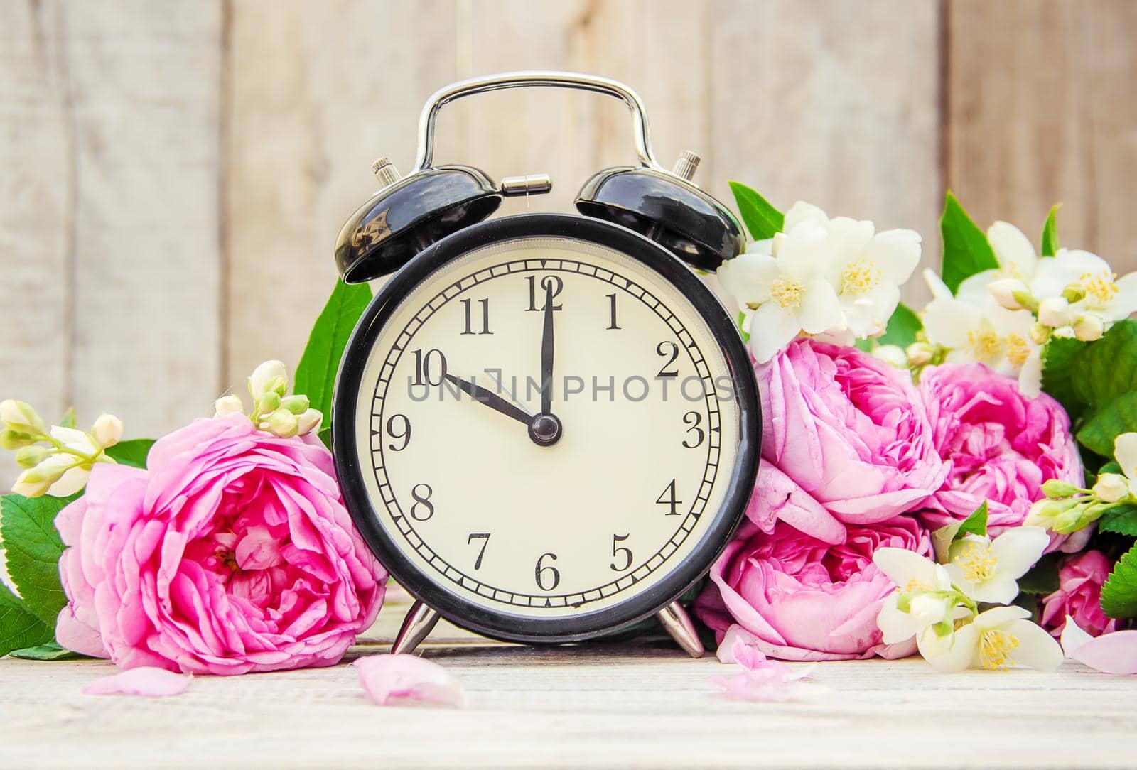 Alarm clock 10 hours. Flowers. Selective focus.