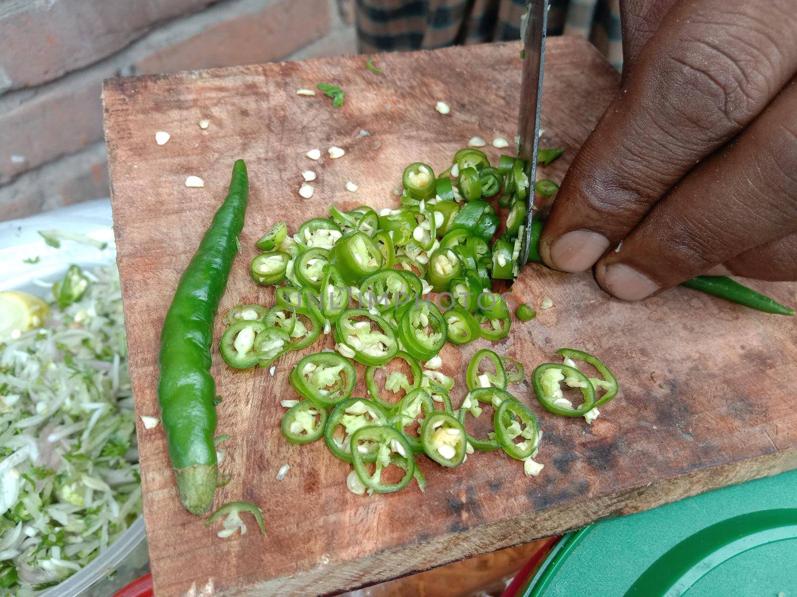 hot slice green chili peppers stock on chopping board for cooking