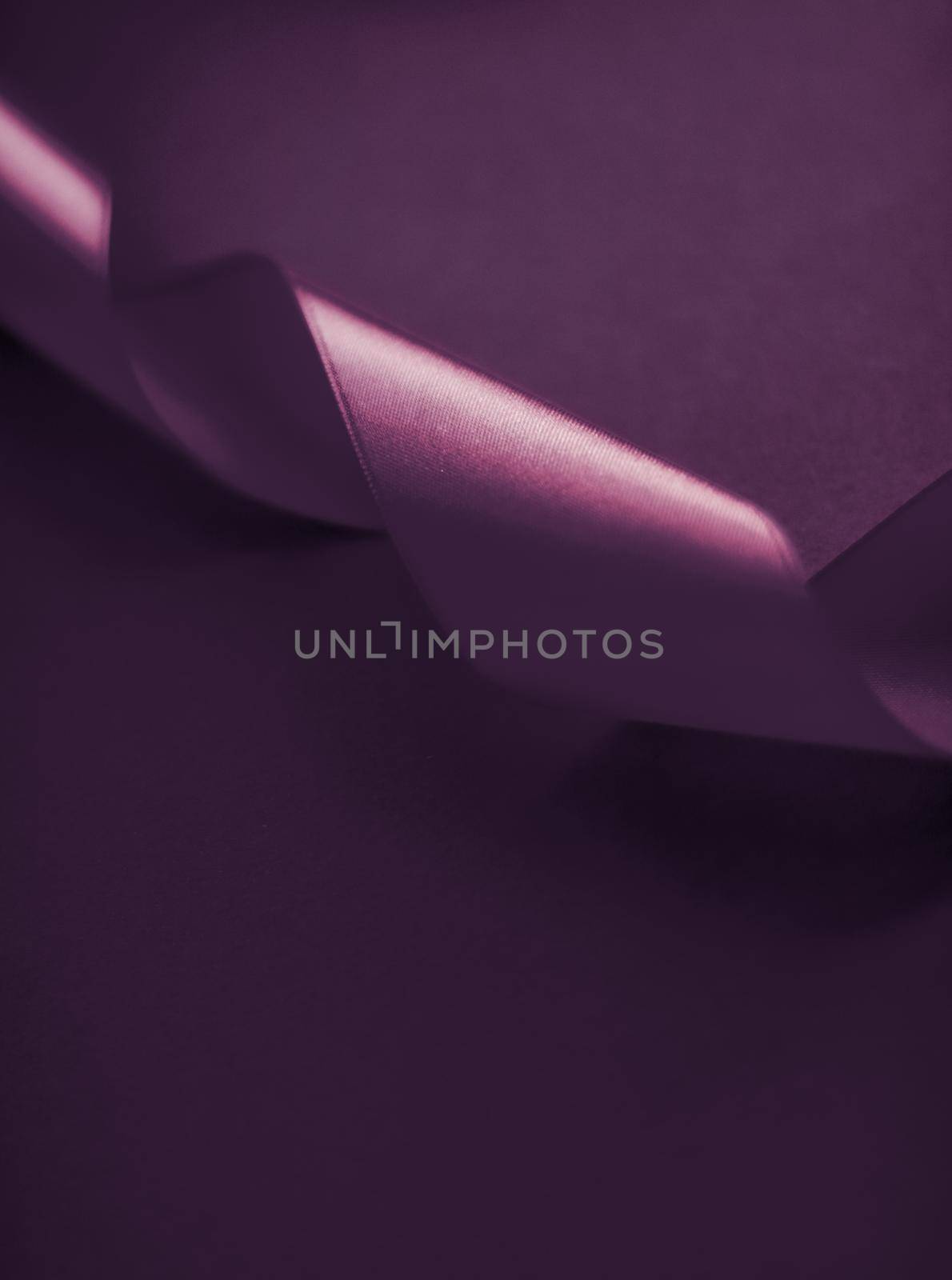 Branding, holidays and luxe brands concept - Abstract curly silk ribbon on purple background, exclusive luxury brand design for holiday sale product promotion and glamour art invitation card backdrop