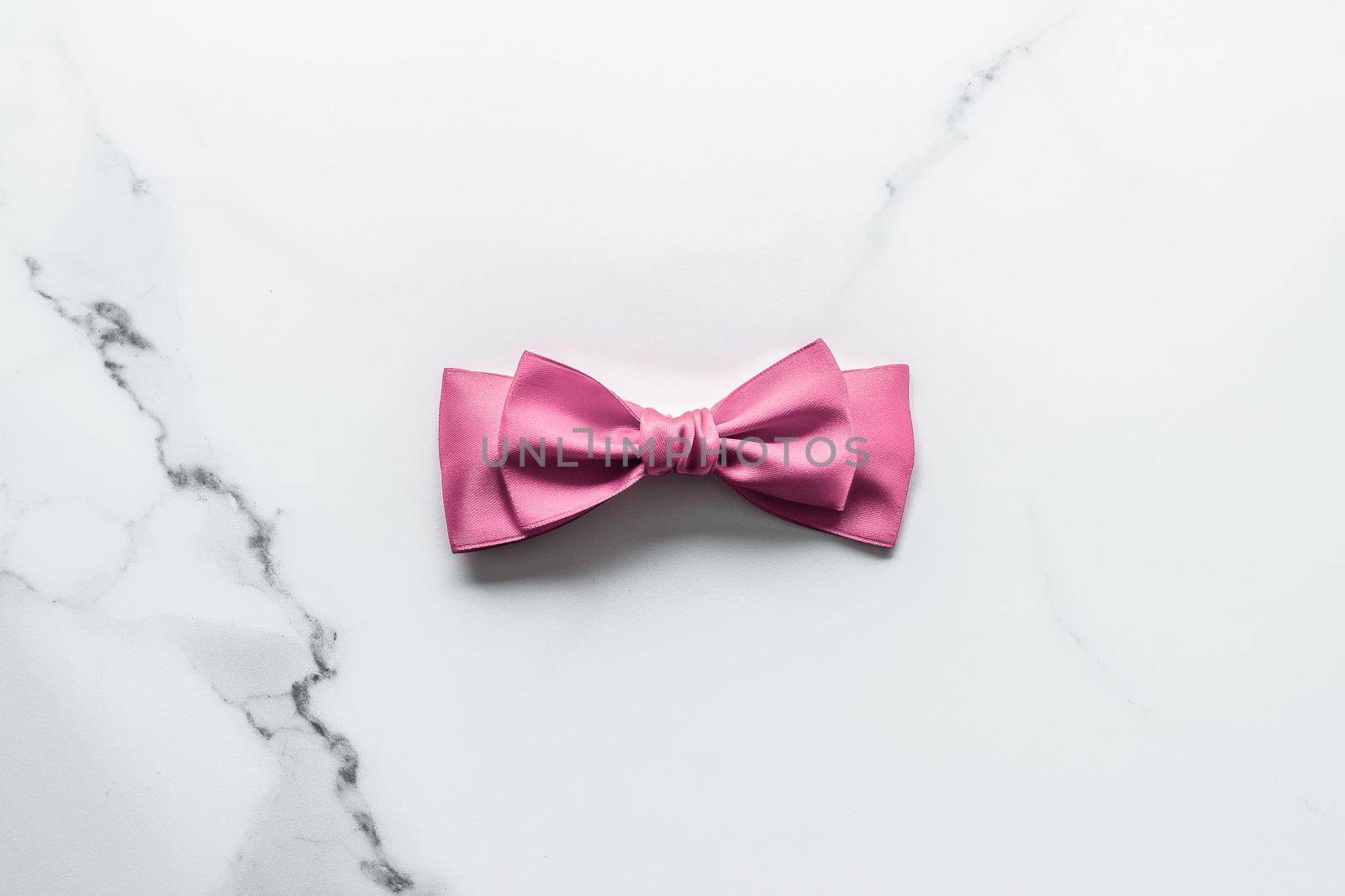 Birthday, wedding and girly branding concept - Pink silk ribbon and bow on marble background, girl baby shower present and glamour fashion gift decor for luxury beauty brand, holiday flatlay design