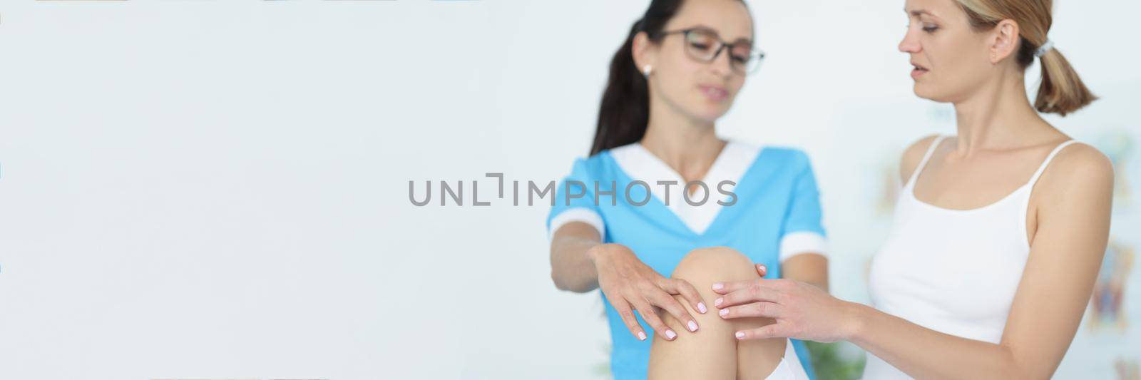 Portrait of physiotherapist give advice to female patient, rehabilitation after injury or accident. Physical therapy, recovery, healthcare, clinic concept