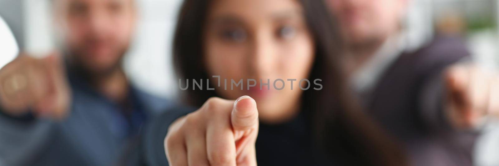 Young businesspeople pointing at you with finger, we choose you, we support you message by kuprevich