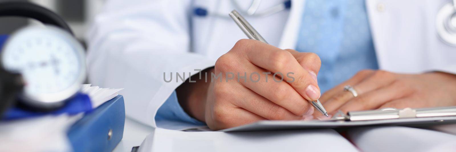 Close-up of doctor fill report or prescribe medication for ill patient, busy head doctor. Qualified medical worker in clinic. Health, consultation concept