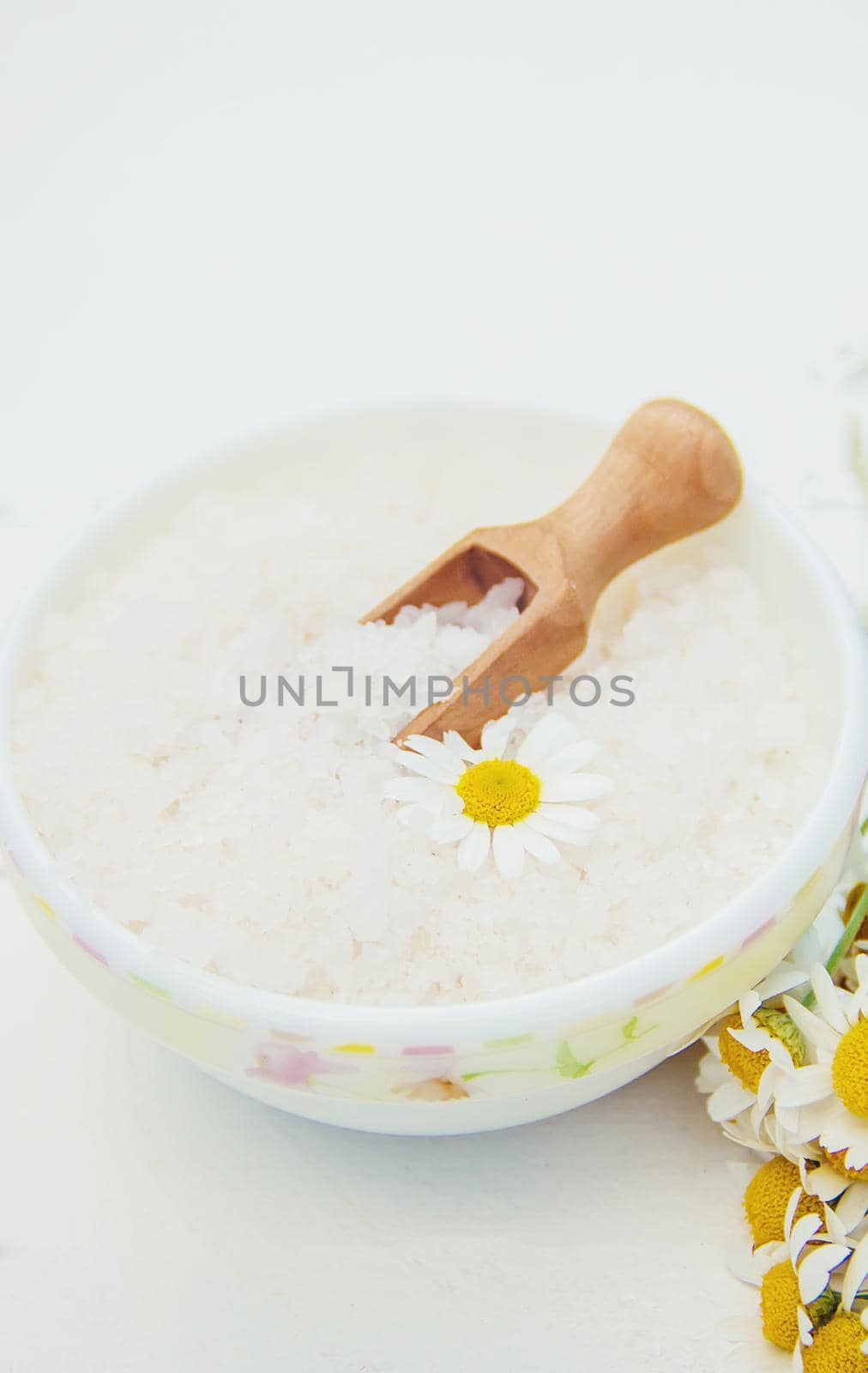 Spa sea salt with chamomile extract. Selective focus.