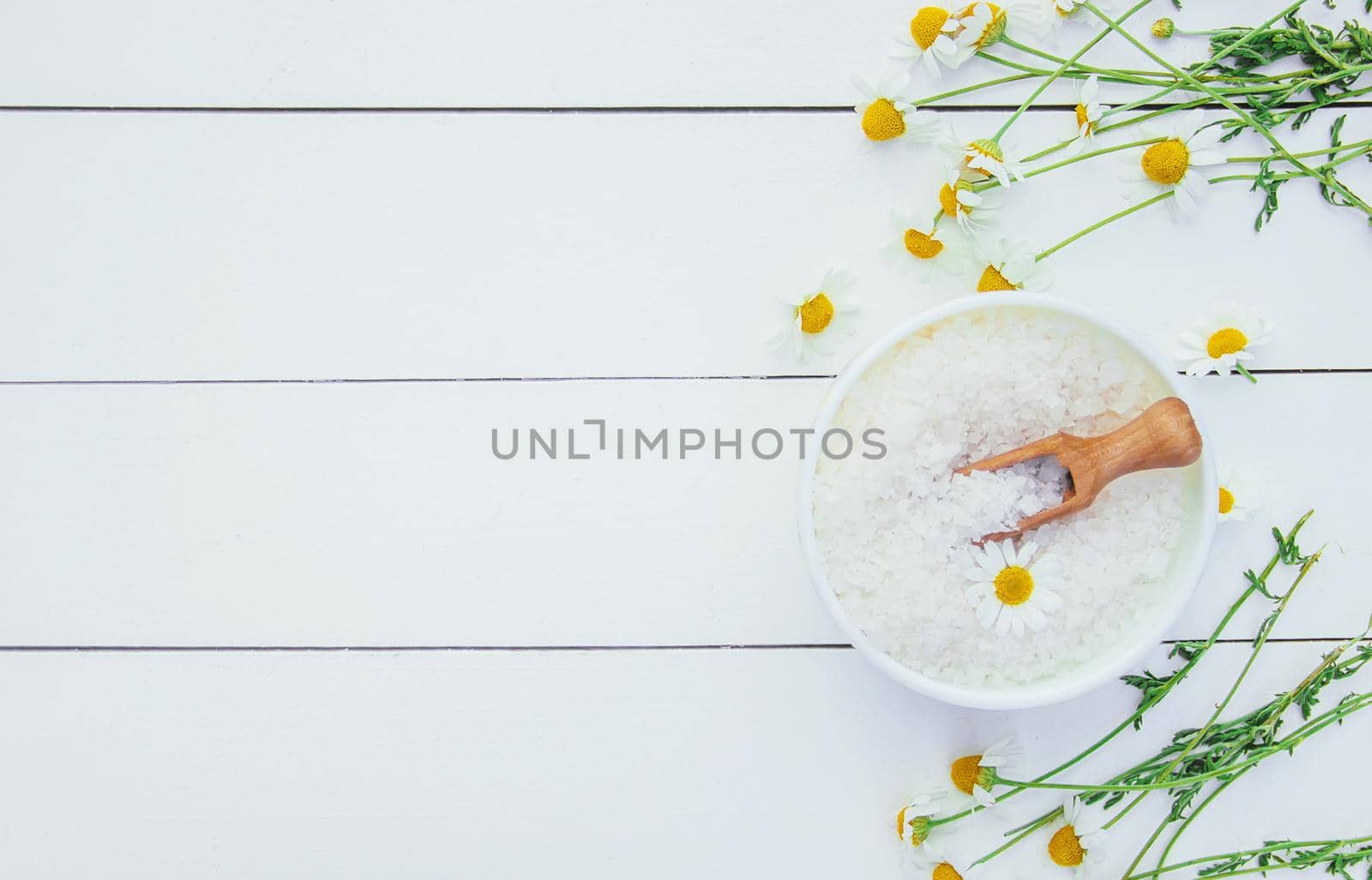 Spa sea salt with chamomile extract. Selective focus.