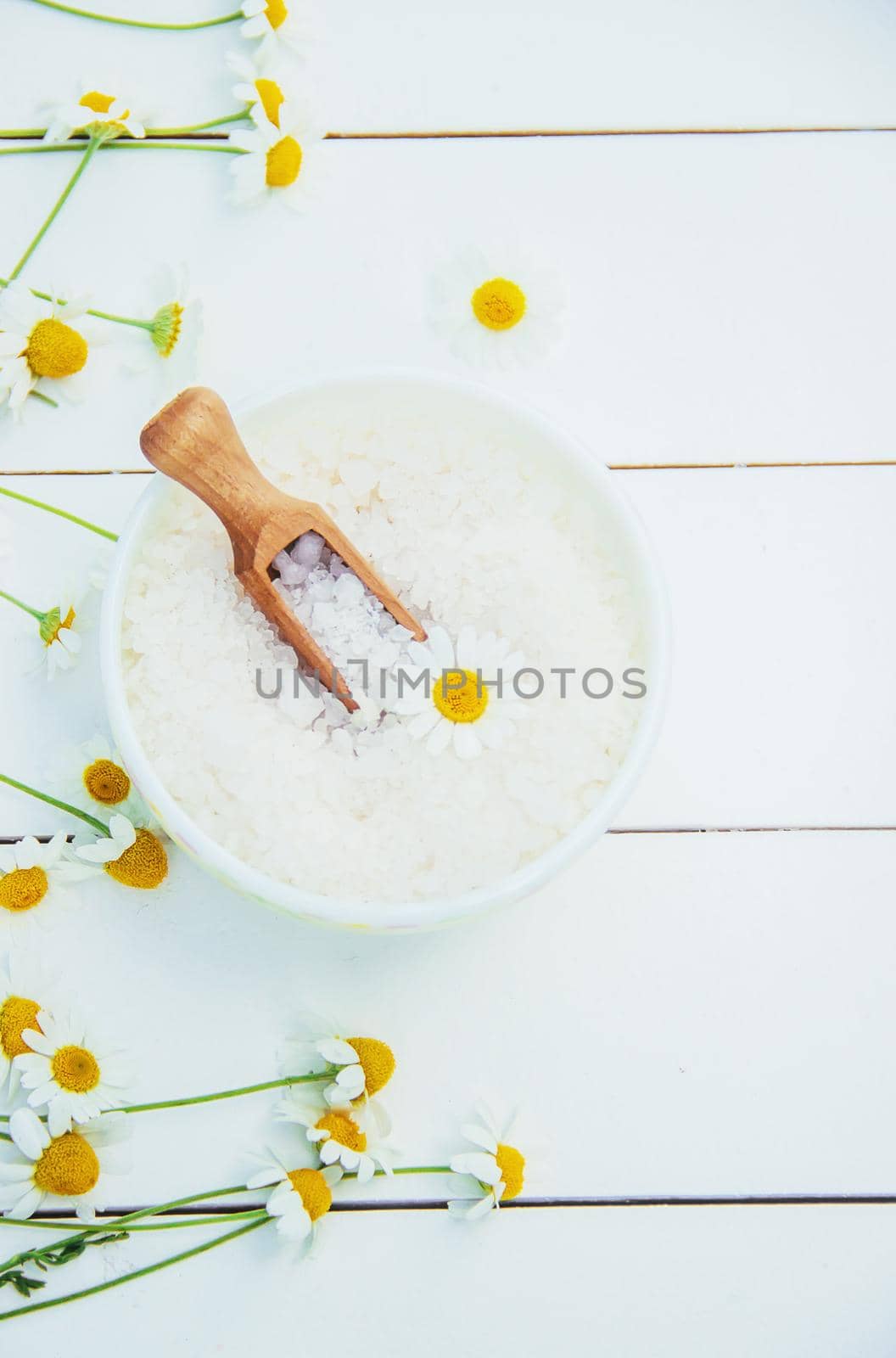 Spa sea salt with chamomile extract. Selective focus.