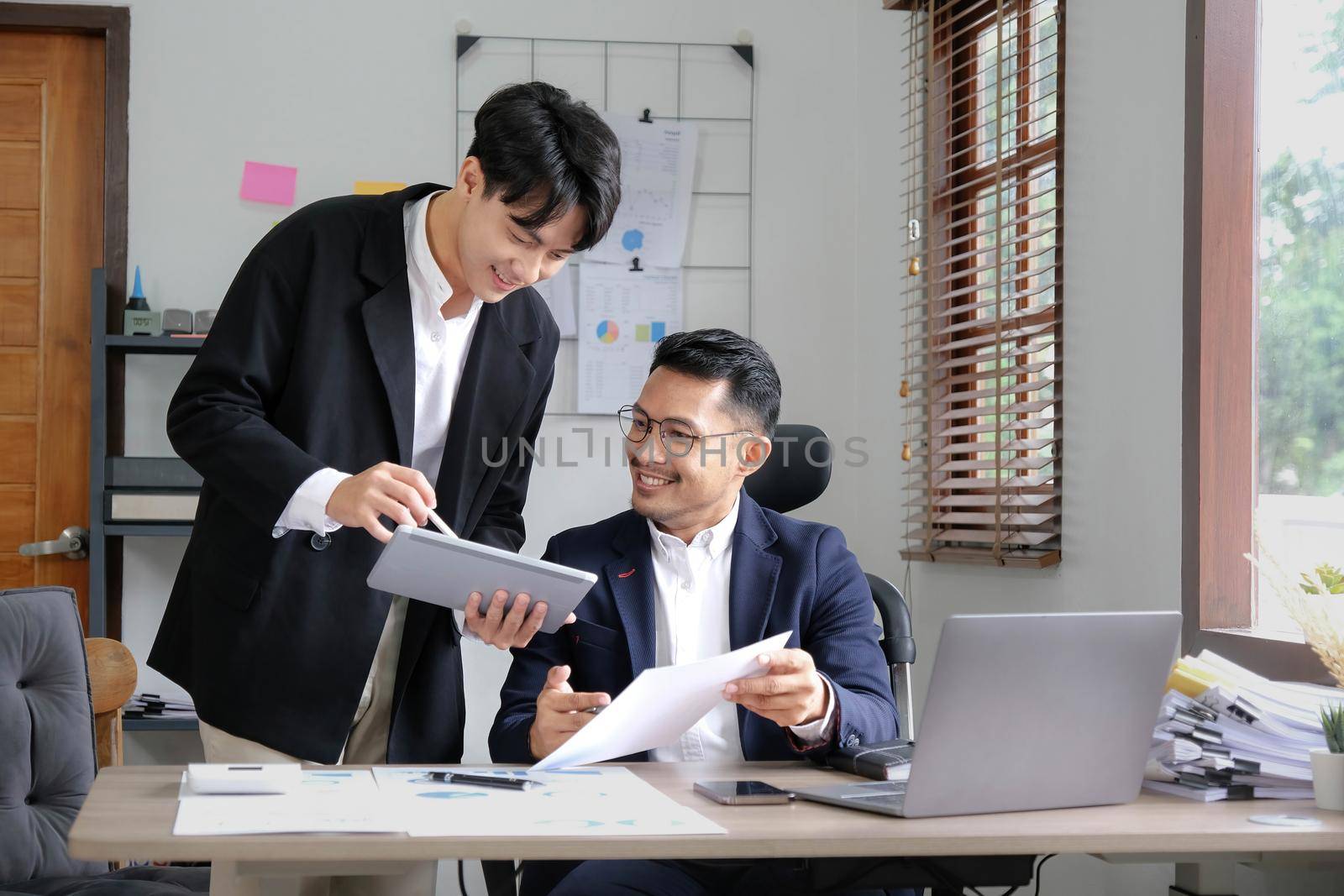 Two Business working at office with documents on desk, meeting to planning analyzing the financial report, business plan investment, finance analysis concept by wichayada