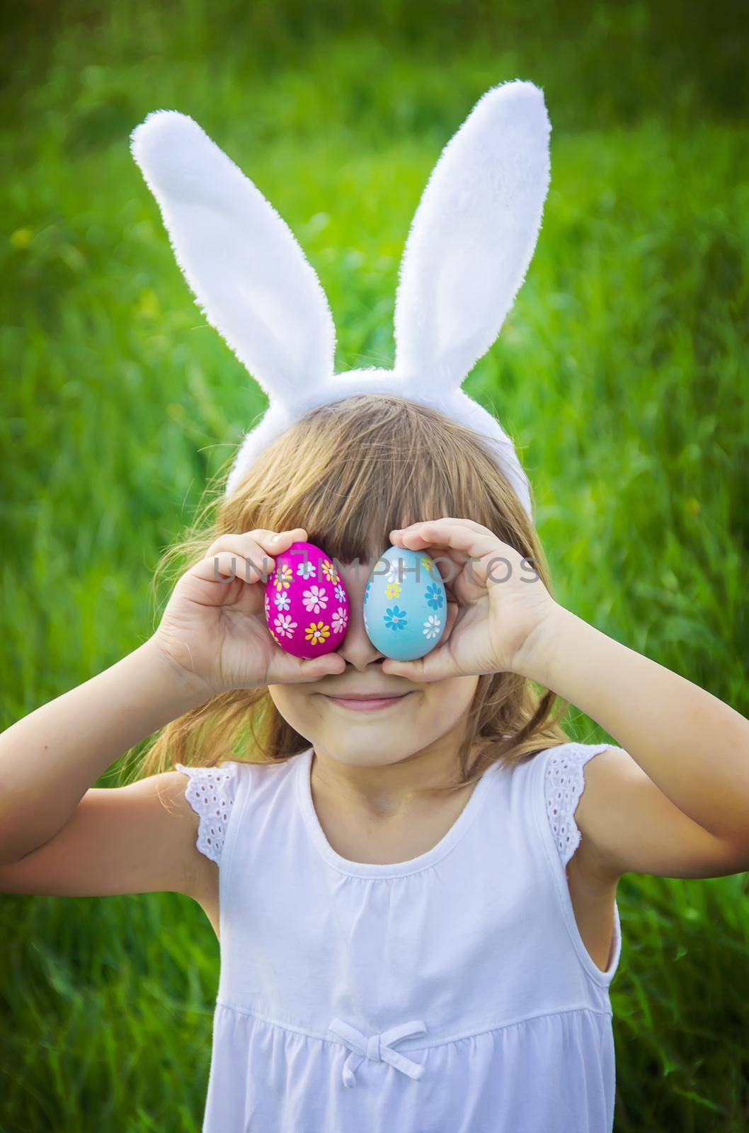 Child with rabbit ears. Easter. Selective focus.