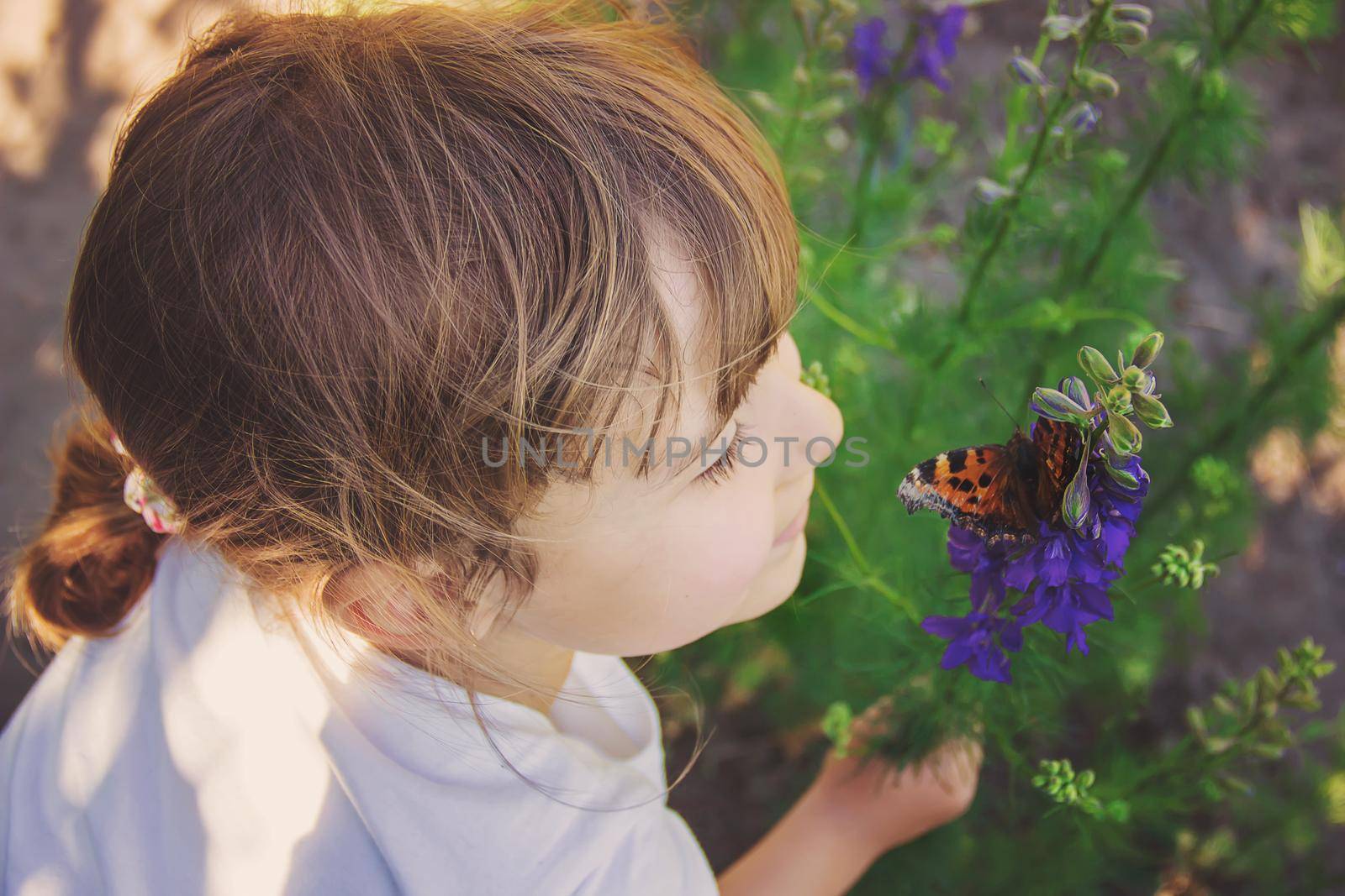 Child with a butterfly. Idea leuconoe. Selective focus.