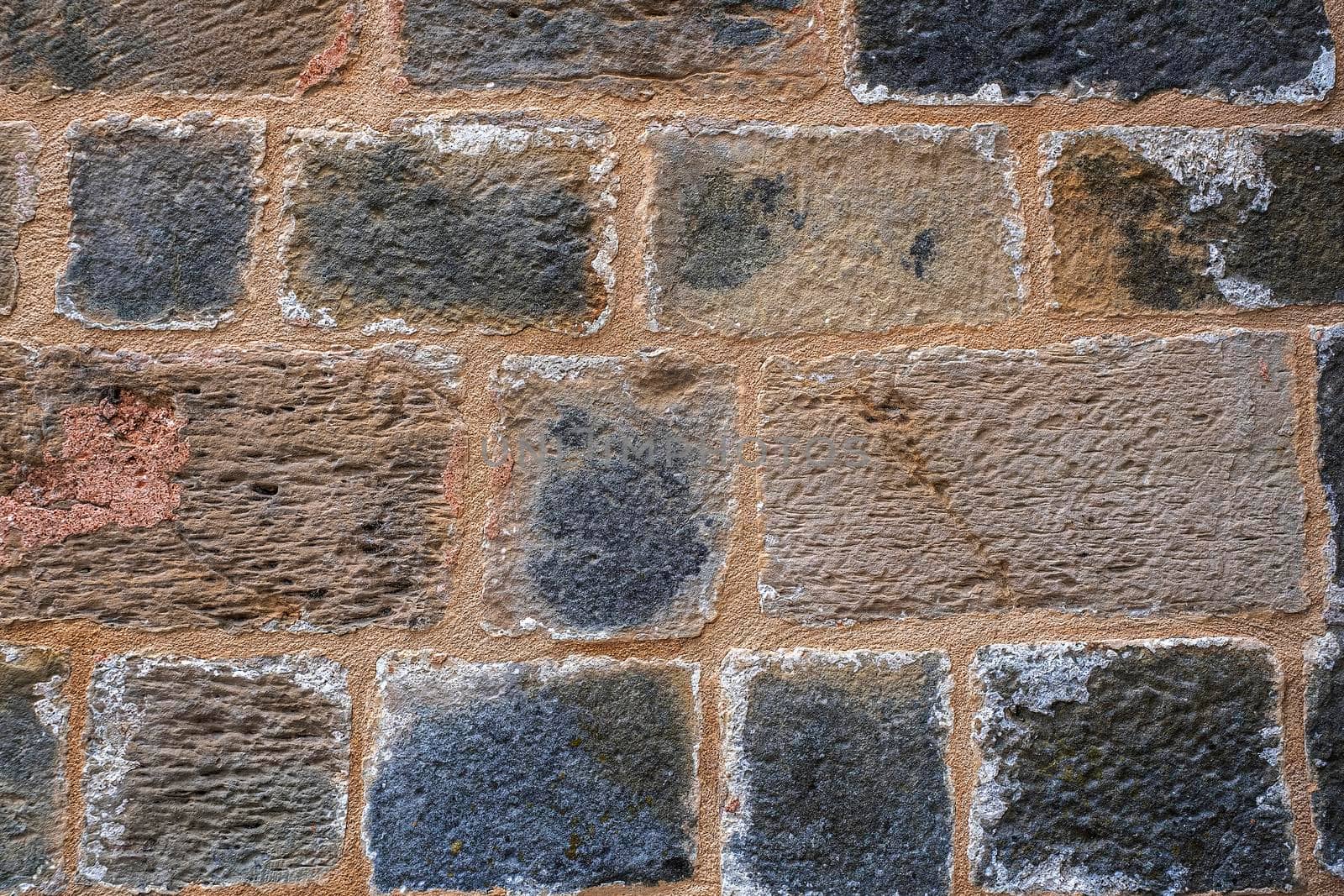 Natural old stone wall texture background with large stones.