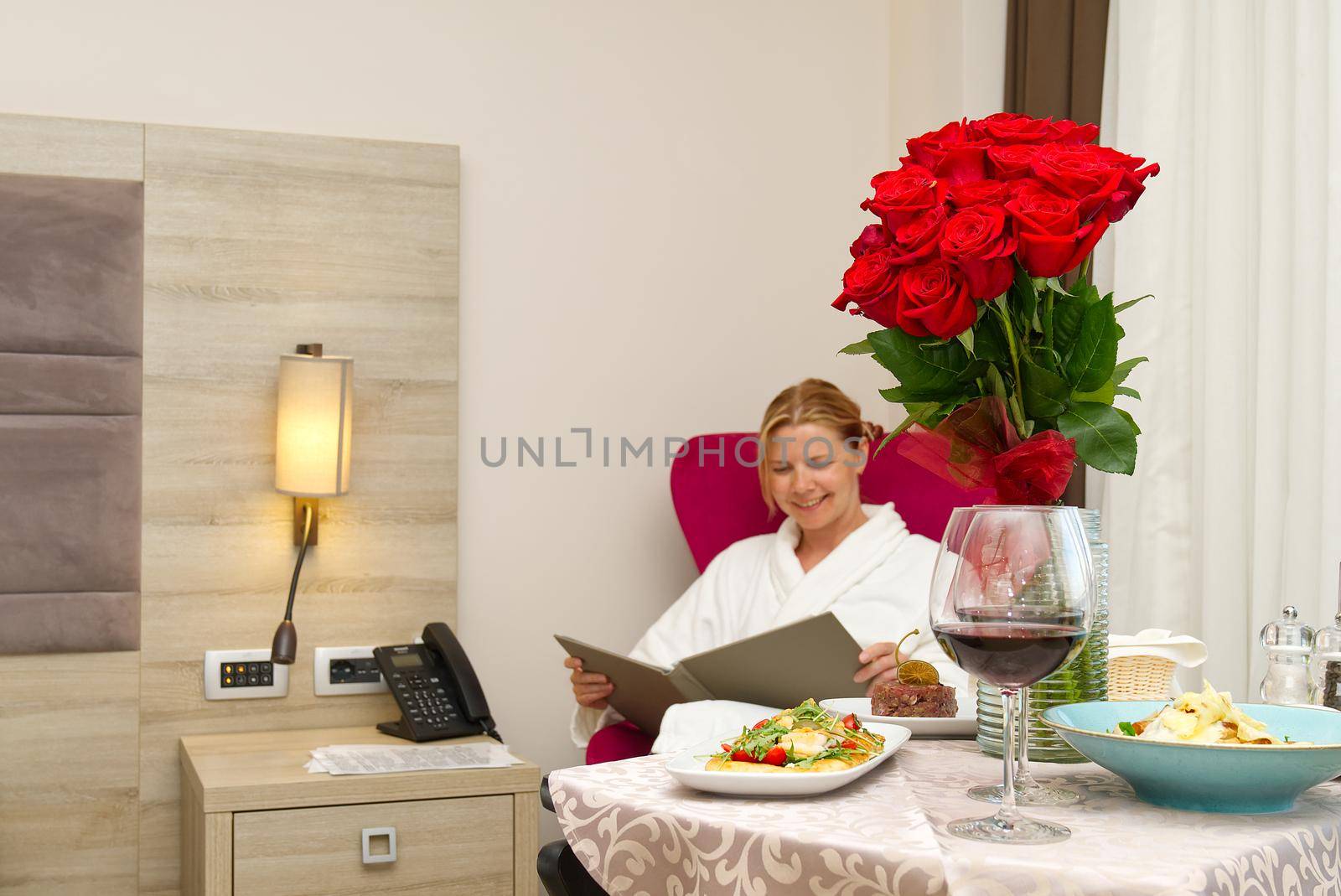 luxury hotel room service, dinner and flowers. Romantic vacation.