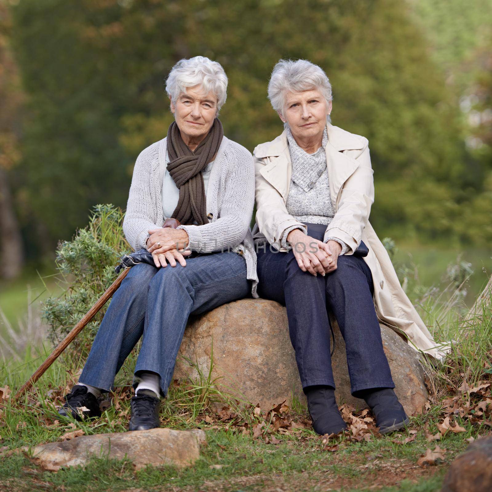 Taking life seriously. Two serious senior women sitting outdoors