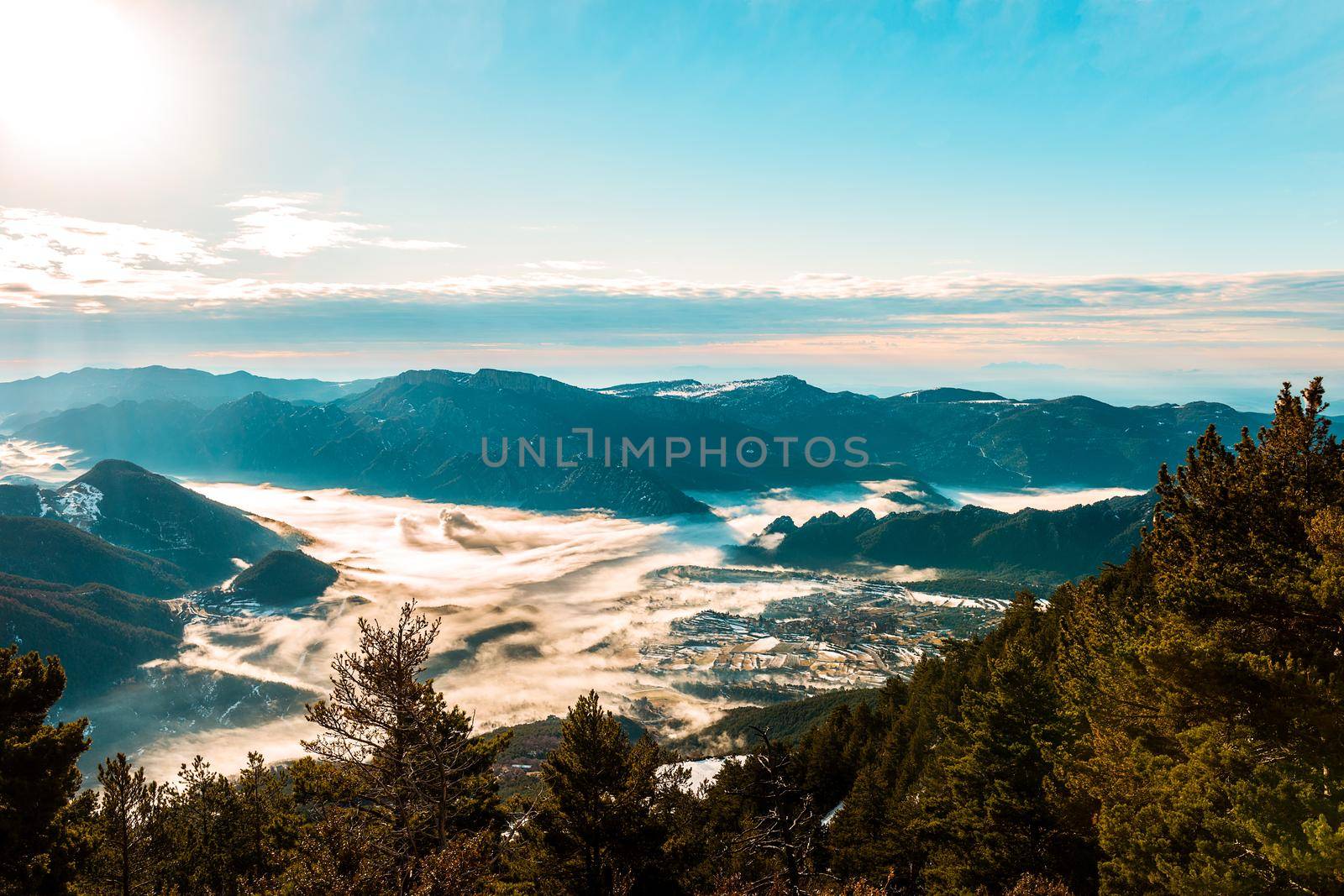 Beautiful view of the mountains in a winter morning, with fog covering all the valley. In the morning the cold weather is make floating mist on the mountain as a sea of fog