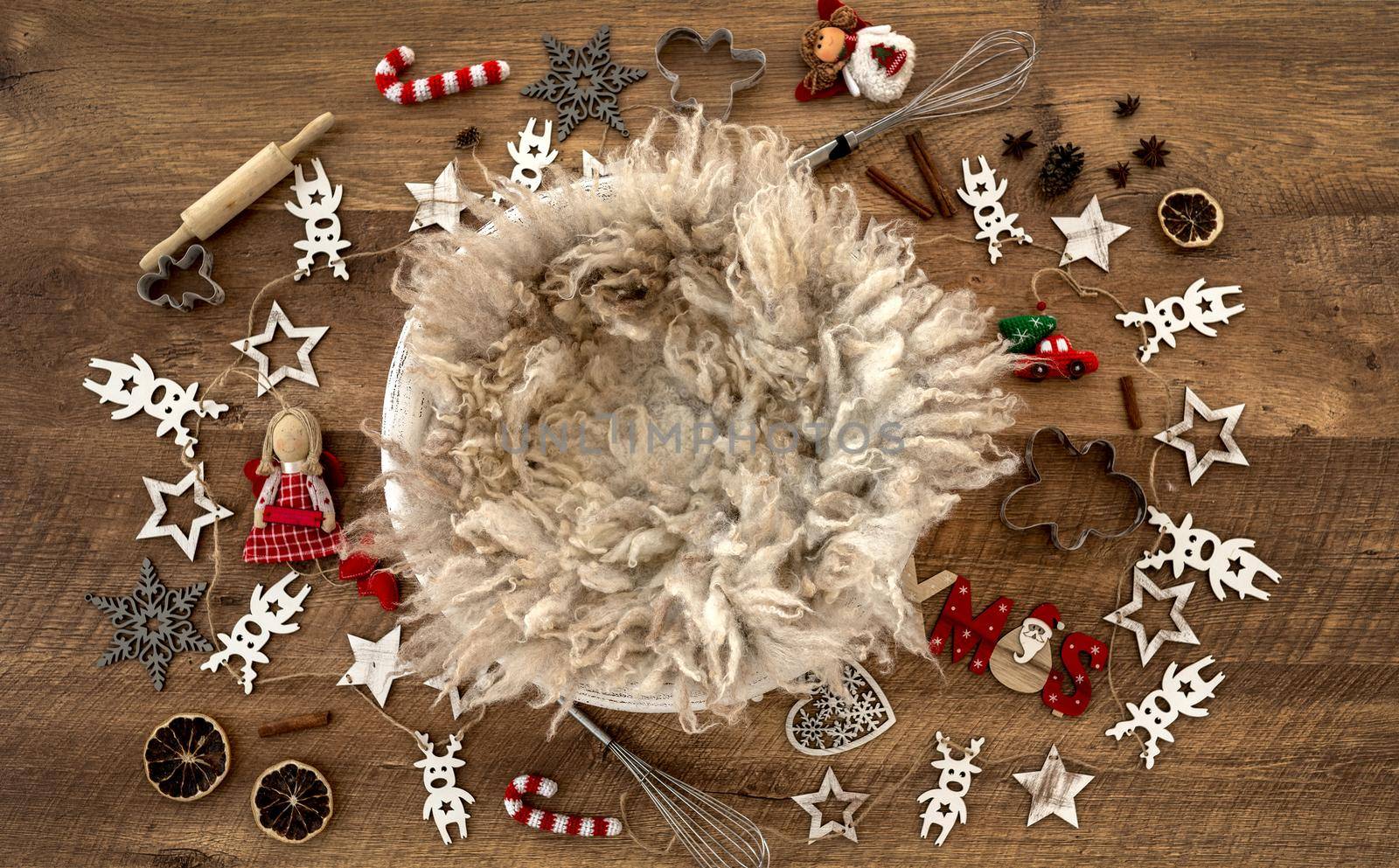Newborn baby studio furniture basket for Christmas infant child photoshoot with fur and Xmas toys and wooden decoration. Tiny designed scene bed for kid New Year holiday studio portrait