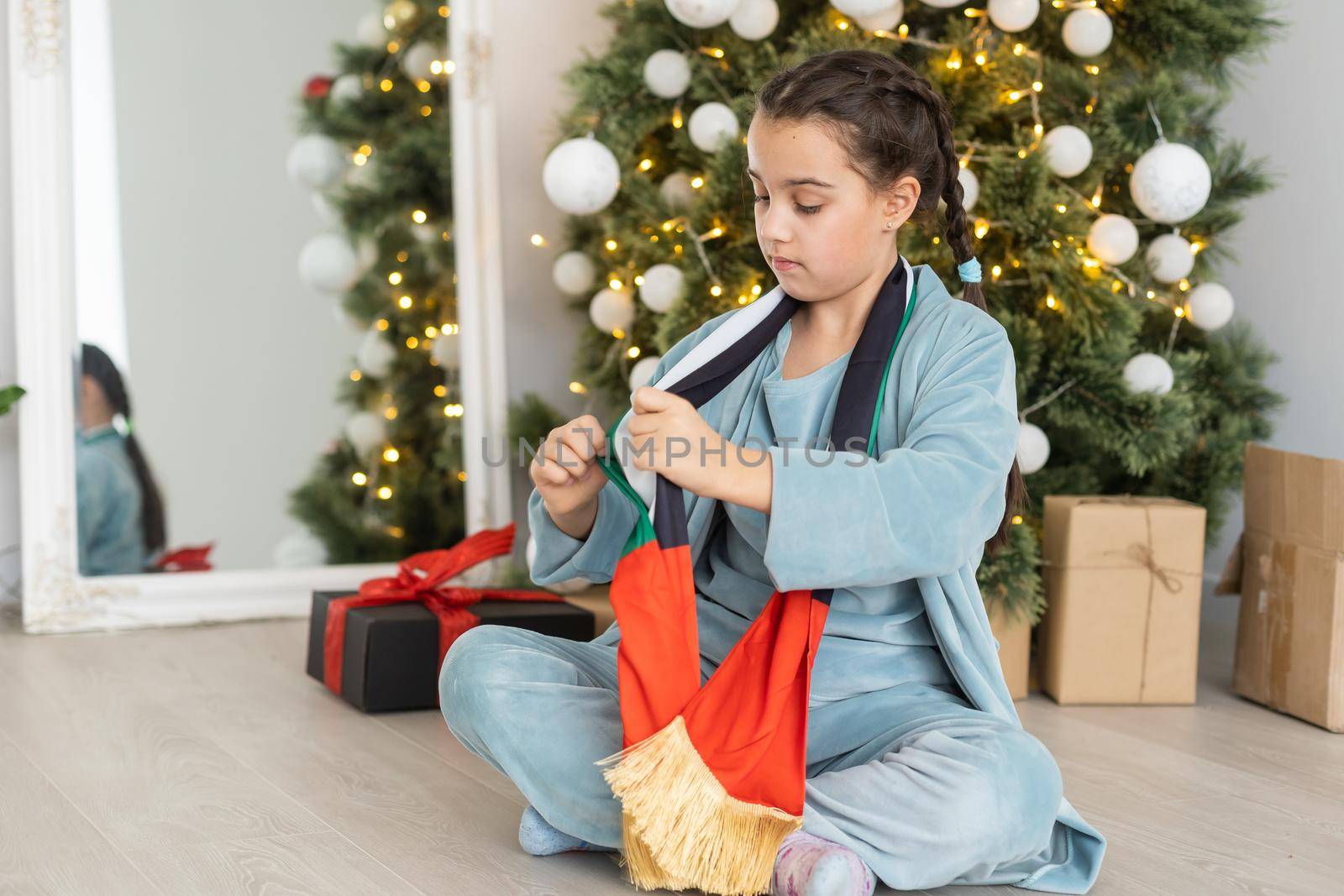 little girl with flag of united arab emirates at christmas.