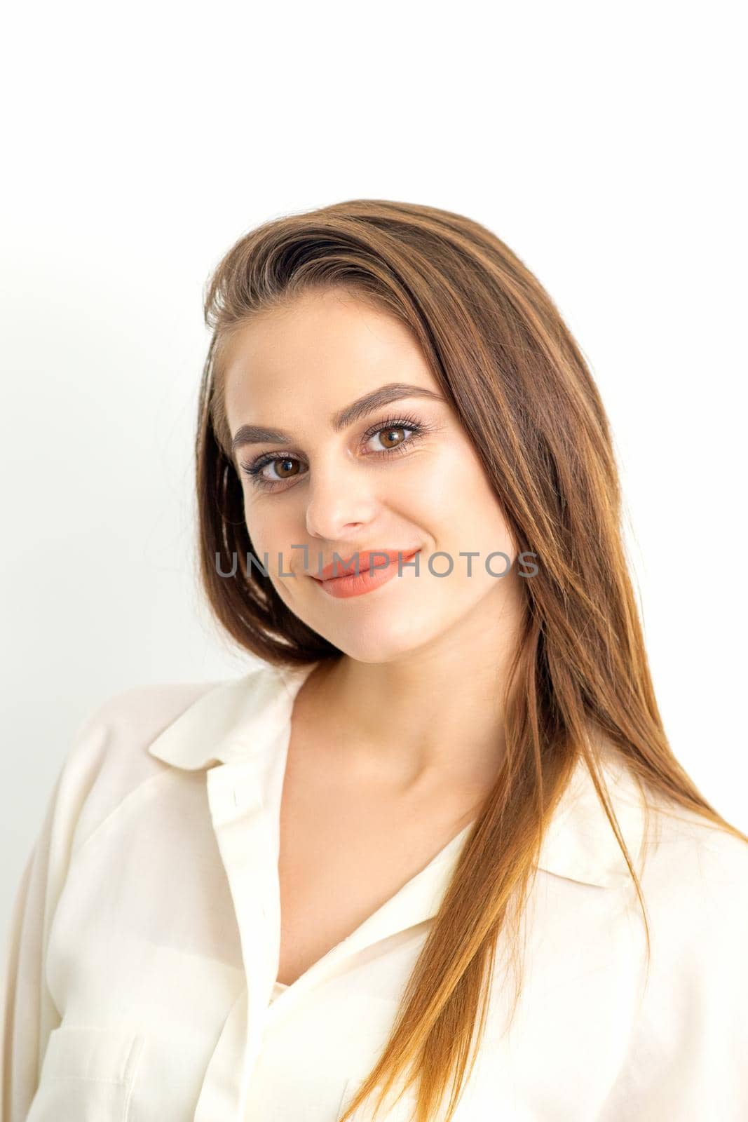 Portrait of a beautiful young caucasian smiling brunette woman on white background
