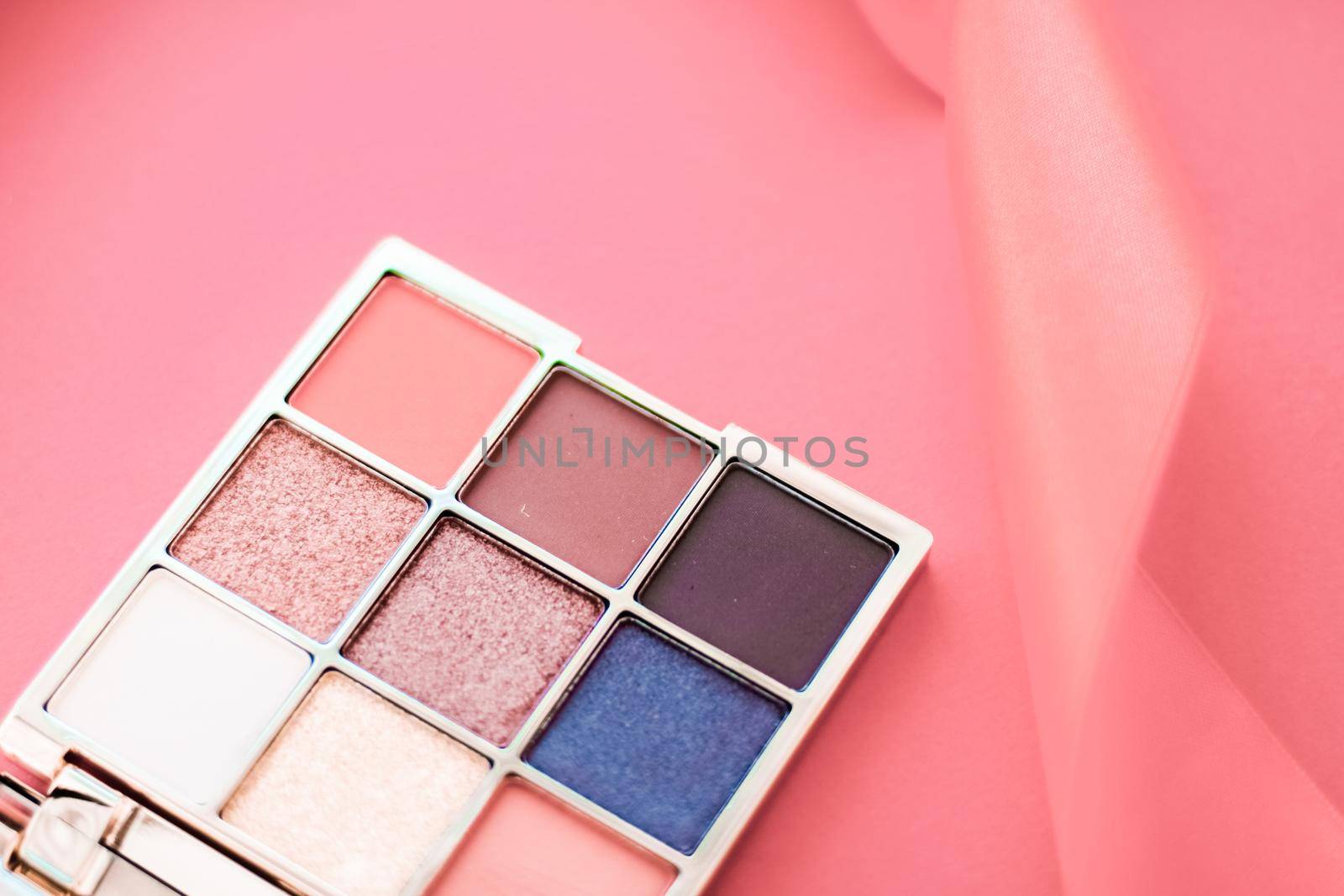 Cosmetic branding, mua and girly concept - Eyeshadow palette and make-up brush on coral background, eye shadows cosmetics product for luxury beauty brand promotion and holiday fashion blog design