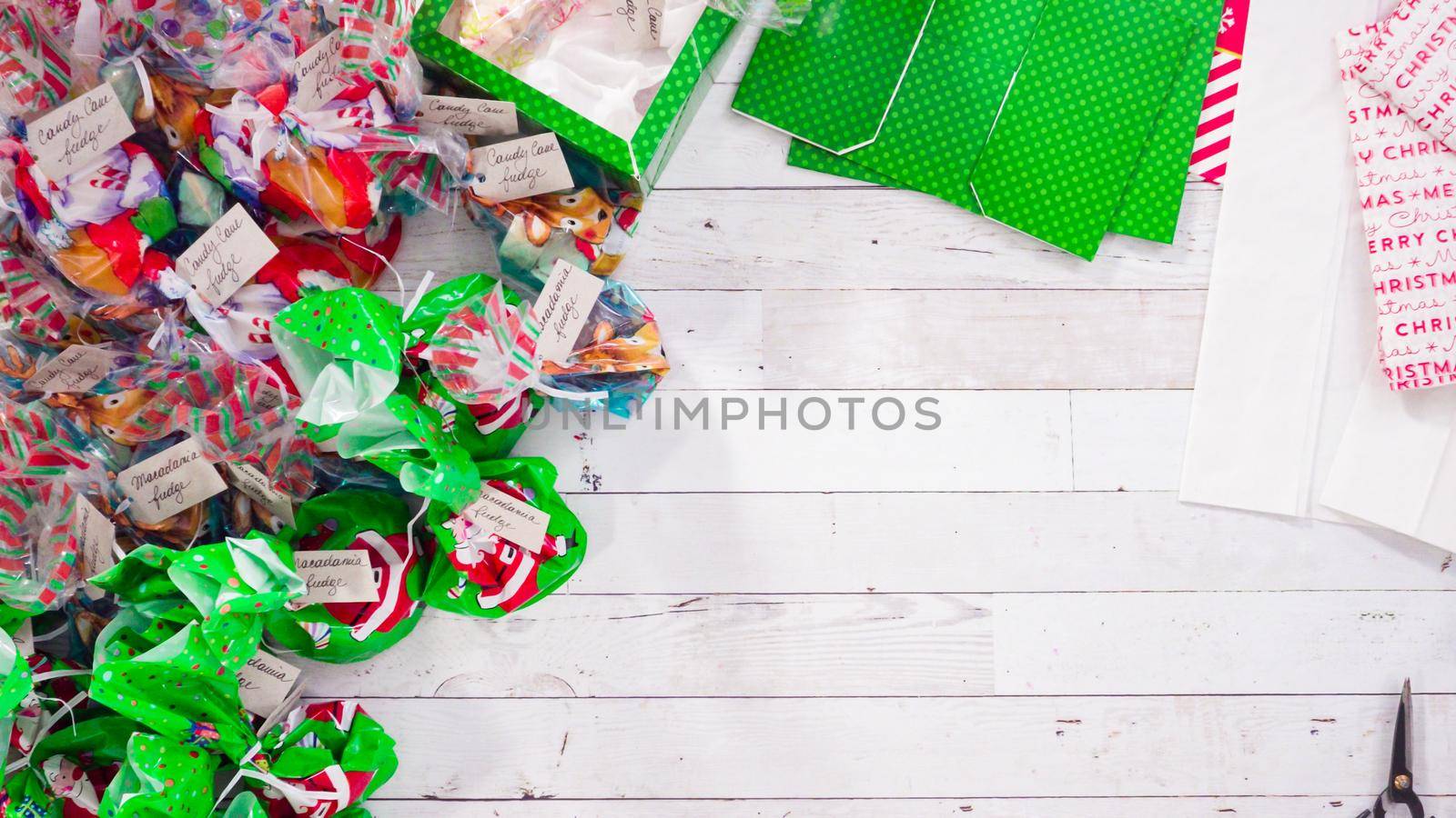 Flat lay. Step by step. Packaging homemade fudge and cookies into a Christmas gift box.