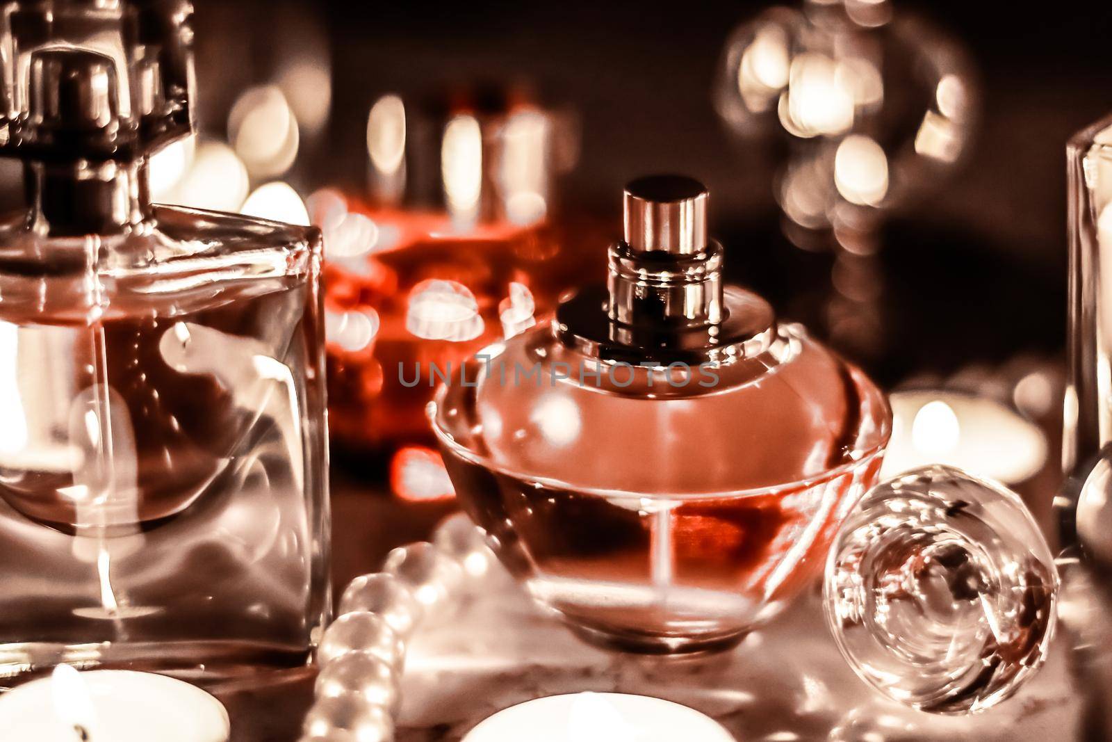 Perfumery, cosmetics branding and luxe concept - Perfume bottle and vintage fragrance on glamour vanity table at night, pearls jewellery and eau de parfum as holiday gift, luxury beauty brand present