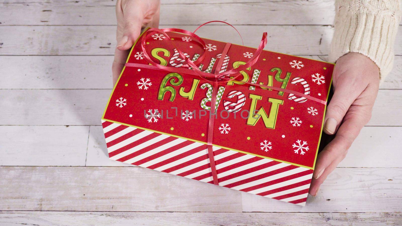 Step by step. Packaging homemade fudge and cookies into a Christmas gift box.