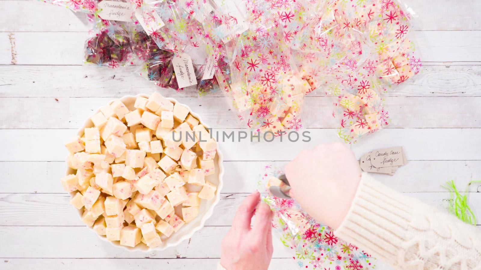Flat lay. Step by step. Packaging homemade candy cane fudge into small gift bags.