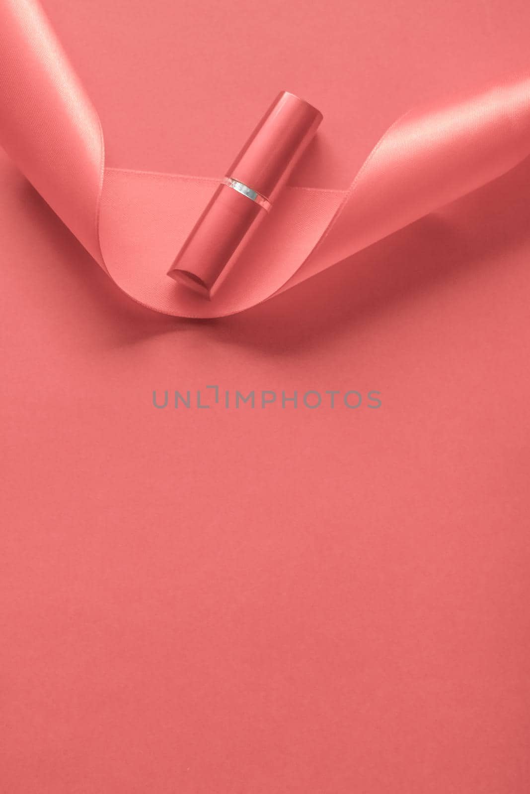 Cosmetic branding, glamour lip gloss and shopping sale concept - Luxury lipstick and silk ribbon on coral holiday background, make-up and cosmetics flatlay for beauty brand product design