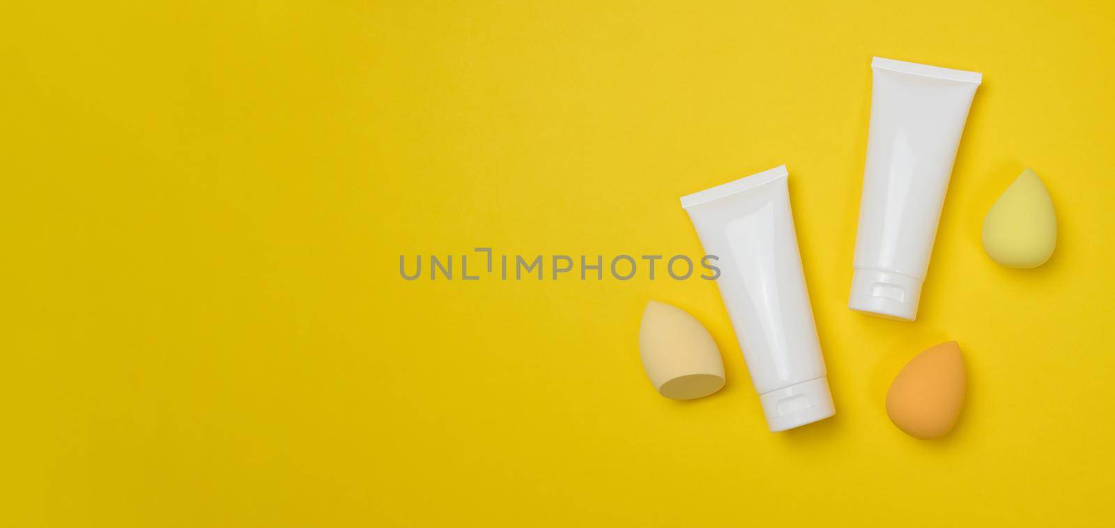 White plastic tubes for cream, gel and other cosmetics and sponges  by ndanko