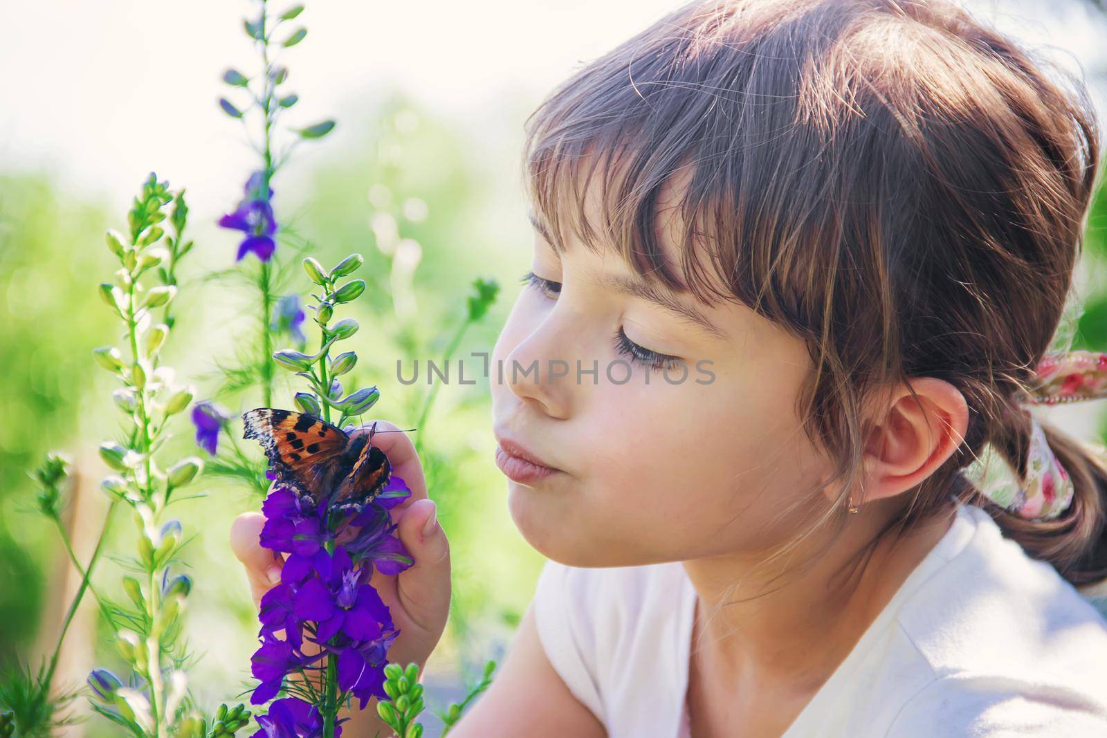 Child with a butterfly. Idea leuconoe. Selective focus.