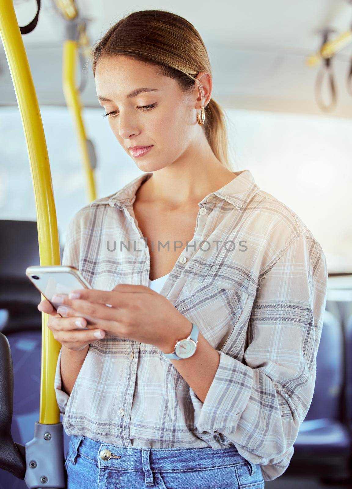 Travel, smartphone and woman on a bus or public transportation reading social media, online news or city website information. Young person with 5g cellphone on train with lens flare for contact us by YuriArcurs