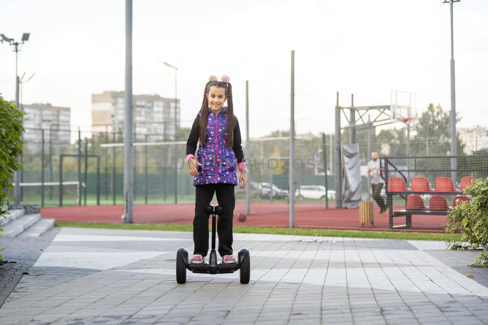 Little Girl Riding Segway Having Fun Spending Weekend