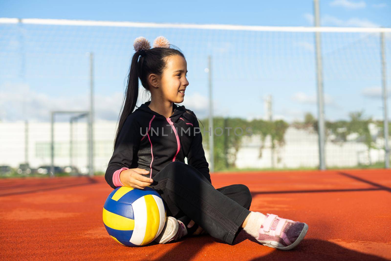 little girl with a volleyball ball.