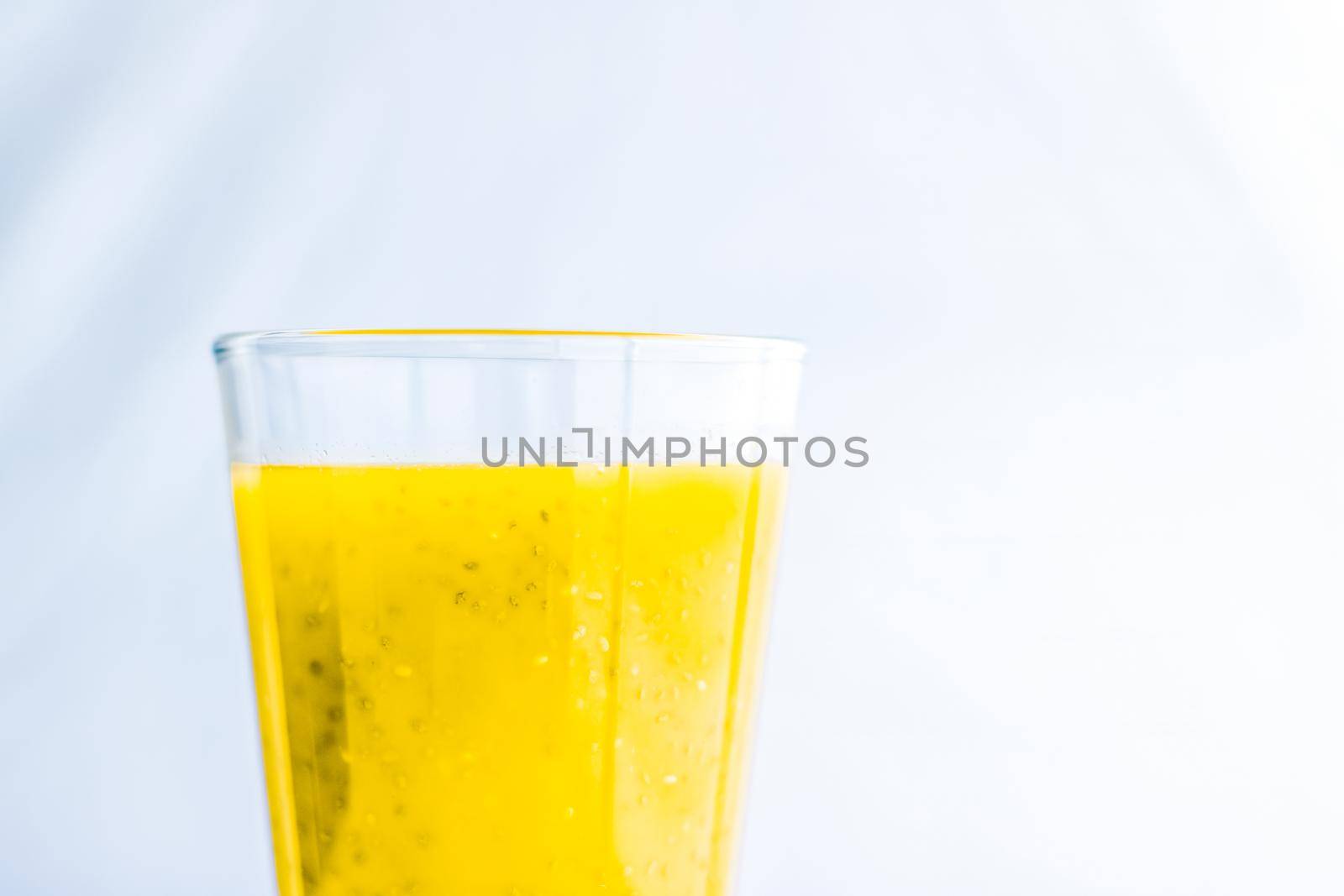 Healthy nutrition, organic drink and fasting cleanse concept - Glass of yellow fruit smoothie juice with chia seeds for diet detox, perfect breakfast recipe