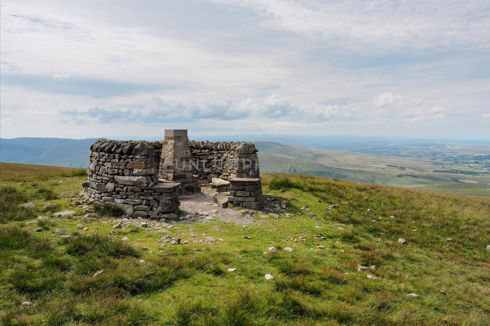 Wild Boar Fell summit and triangulation point enclosed by a circle of dry stone walls, Eden Valley, Cumbria, UK
