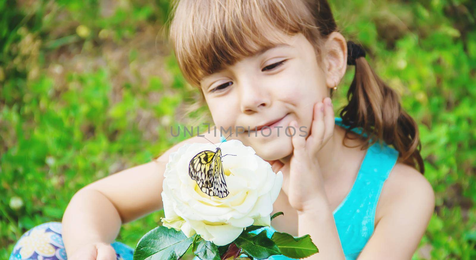 Child with a butterfly. Idea leuconoe. Selective focus.